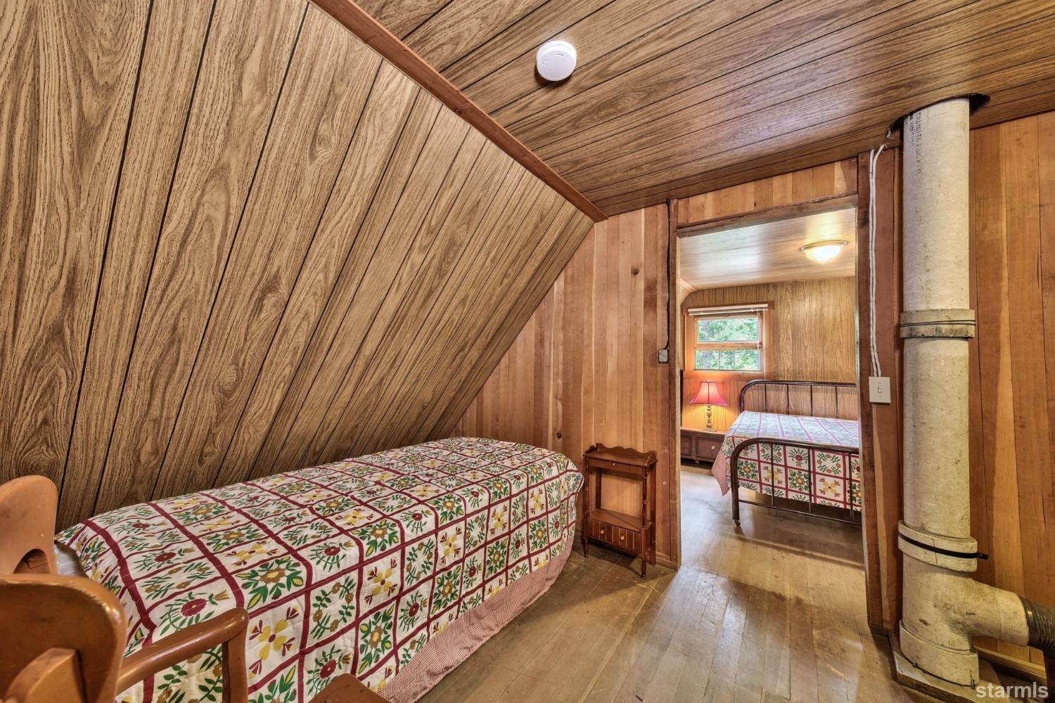 39 Milestone Road, Unit 32 Kyburz, CA 95720 - Photo 19 of 21 a bedroom with a bed and wooden floor