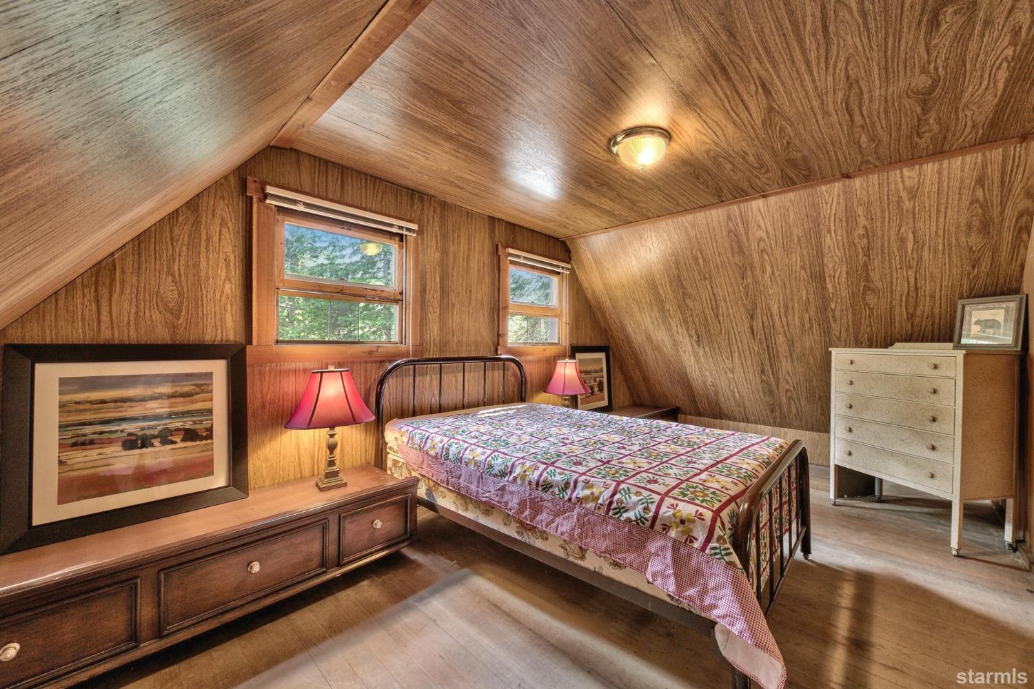 39 Milestone Road, Unit 32 Kyburz, CA 95720 - Photo 20 of 21 a bedroom with a bed and a dresser with wooden floor