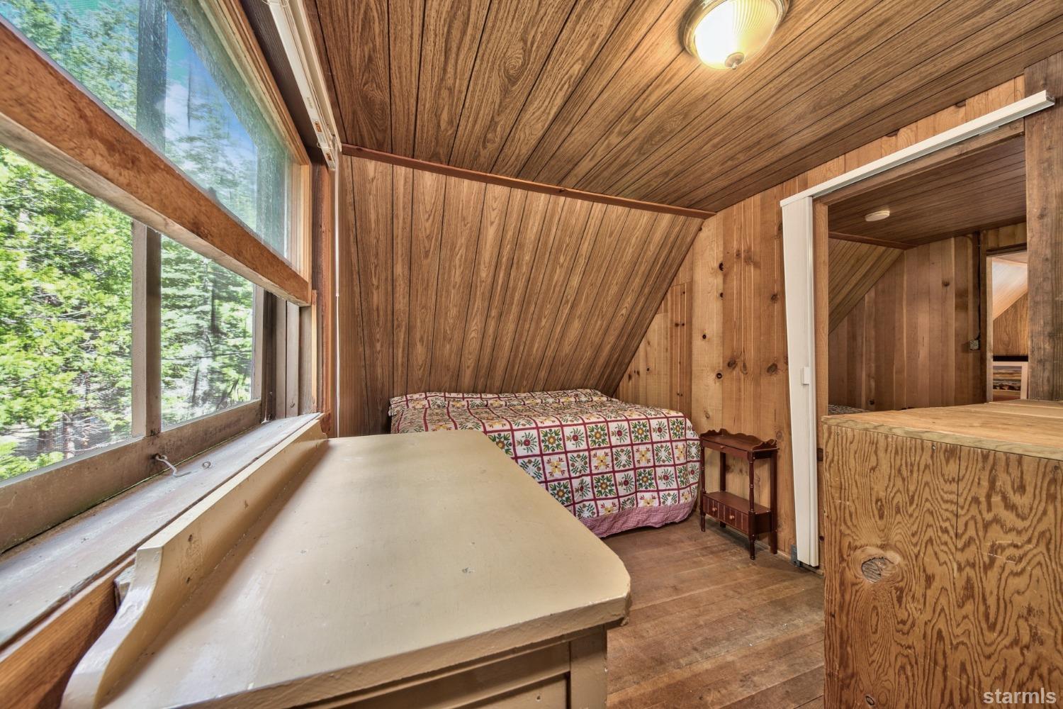 39 Milestone Road, Unit 32 Kyburz, CA 95720 - Photo 21 of 21 a bedroom with a bed and a window