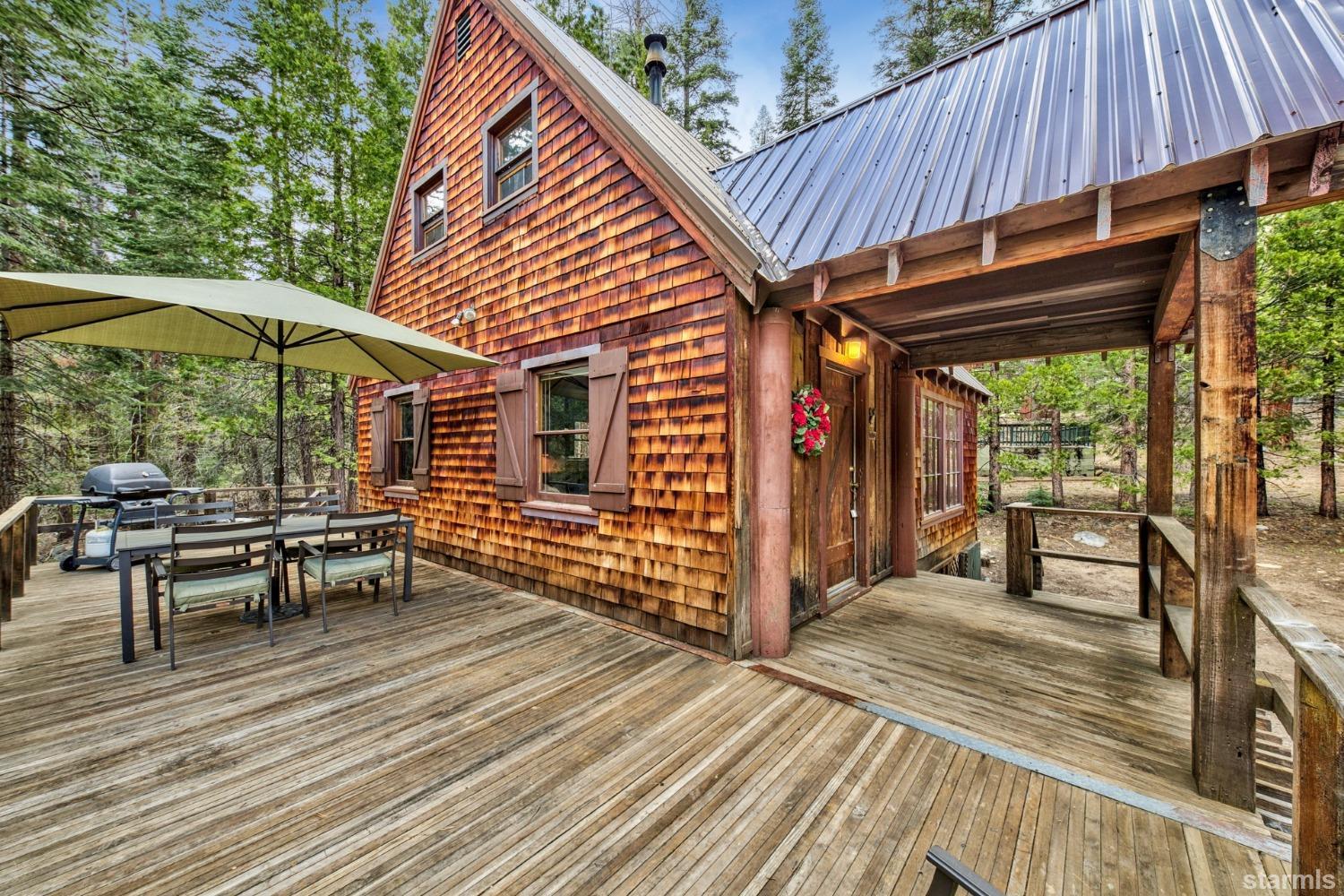 39 Milestone Road, Unit 32 Kyburz, CA 95720 - Photo 4 of 21 a view of a chairs and table on the wooden deck
