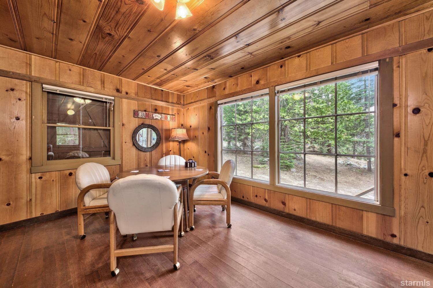 39 Milestone Road, Unit 32 Kyburz, CA 95720 - Photo 9 of 21 a dining room with furniture a chandelier and wooden floor