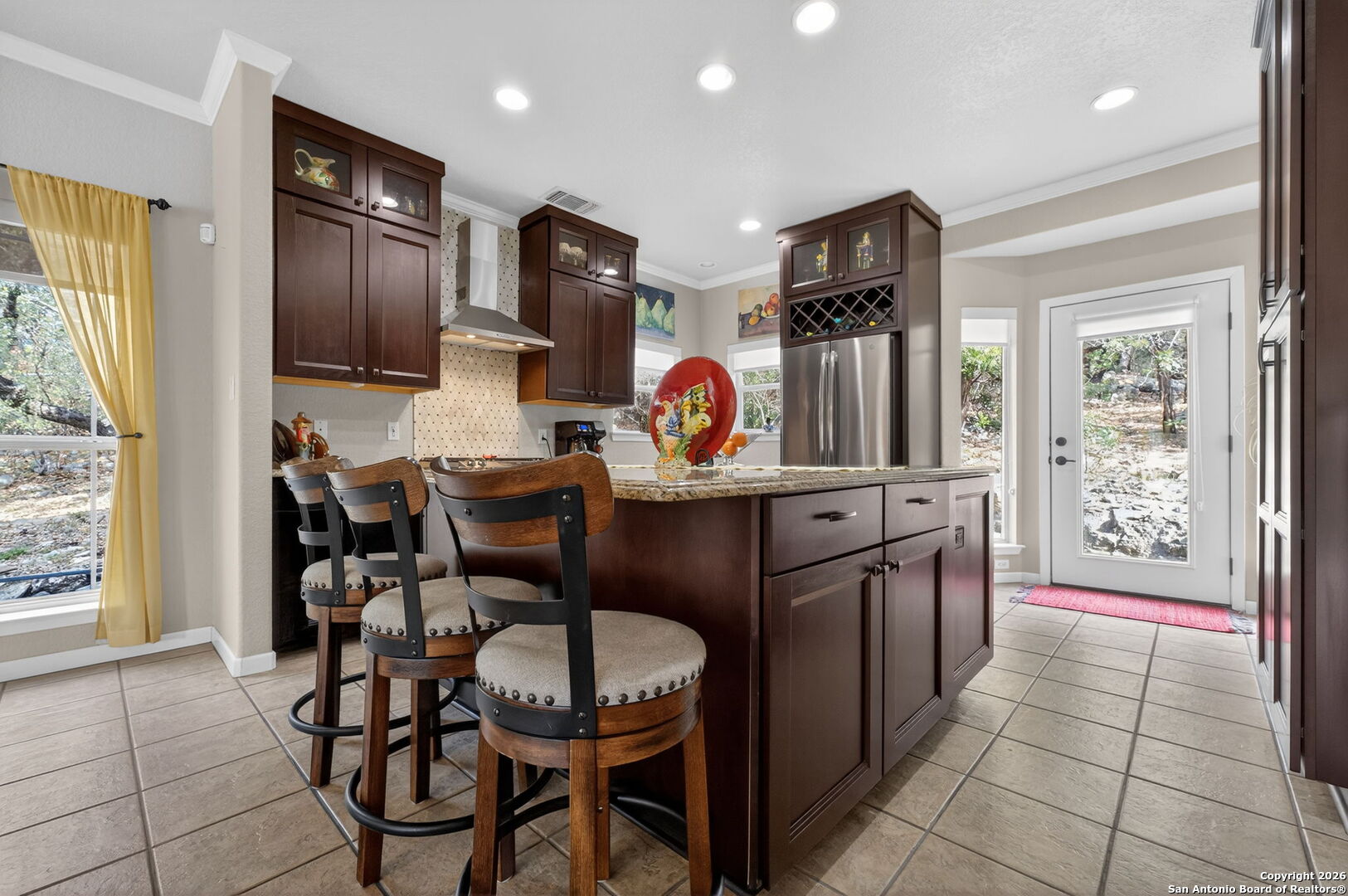 14802 Cross Xd Trail Helotes, TX 78023 - Photo 11 of 58 a kitchen with stainless steel appliances granite countertop a refrigerator and a stove top oven