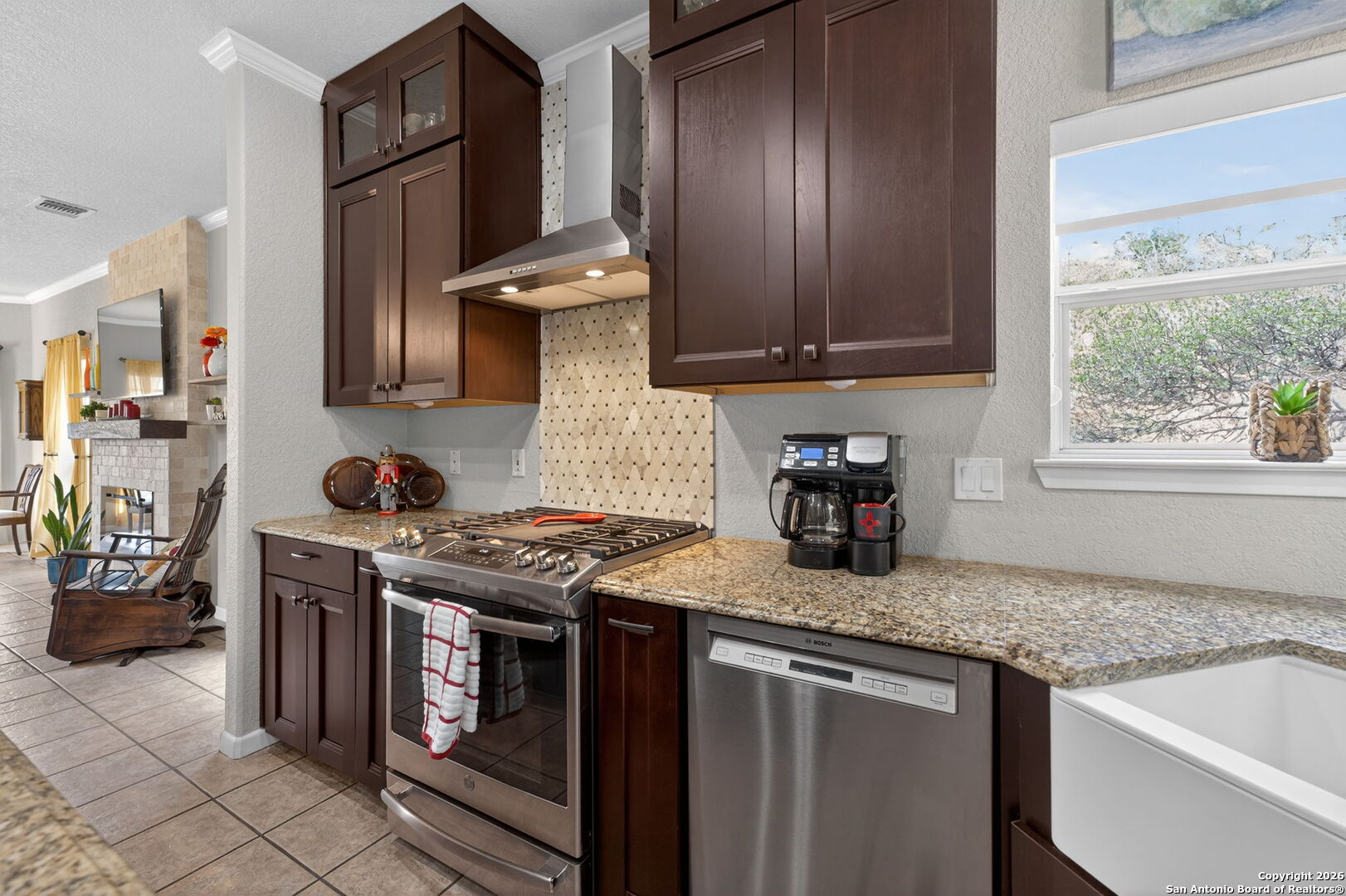 14802 Cross Xd Trail Helotes, TX 78023 - Photo 15 of 58 a kitchen with granite countertop a sink stove and cabinets