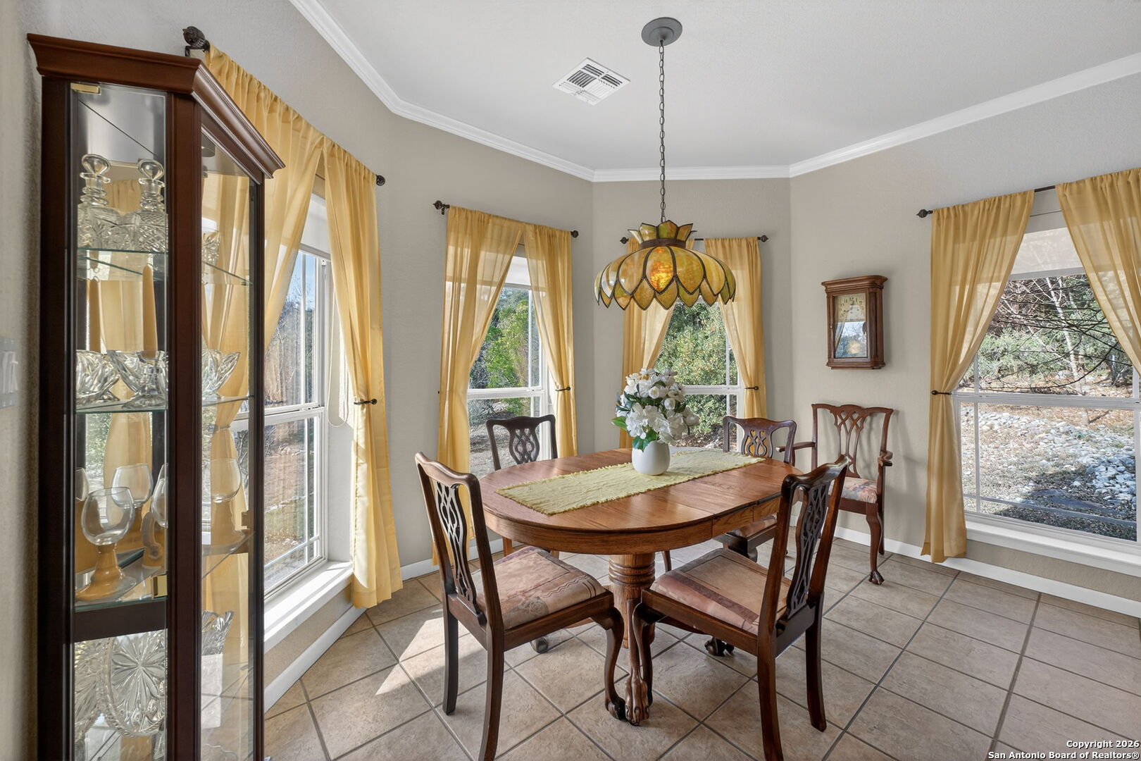 14802 Cross Xd Trail Helotes, TX 78023 - Photo 18 of 58 a view of a dining room with furniture large windows and wooden floor