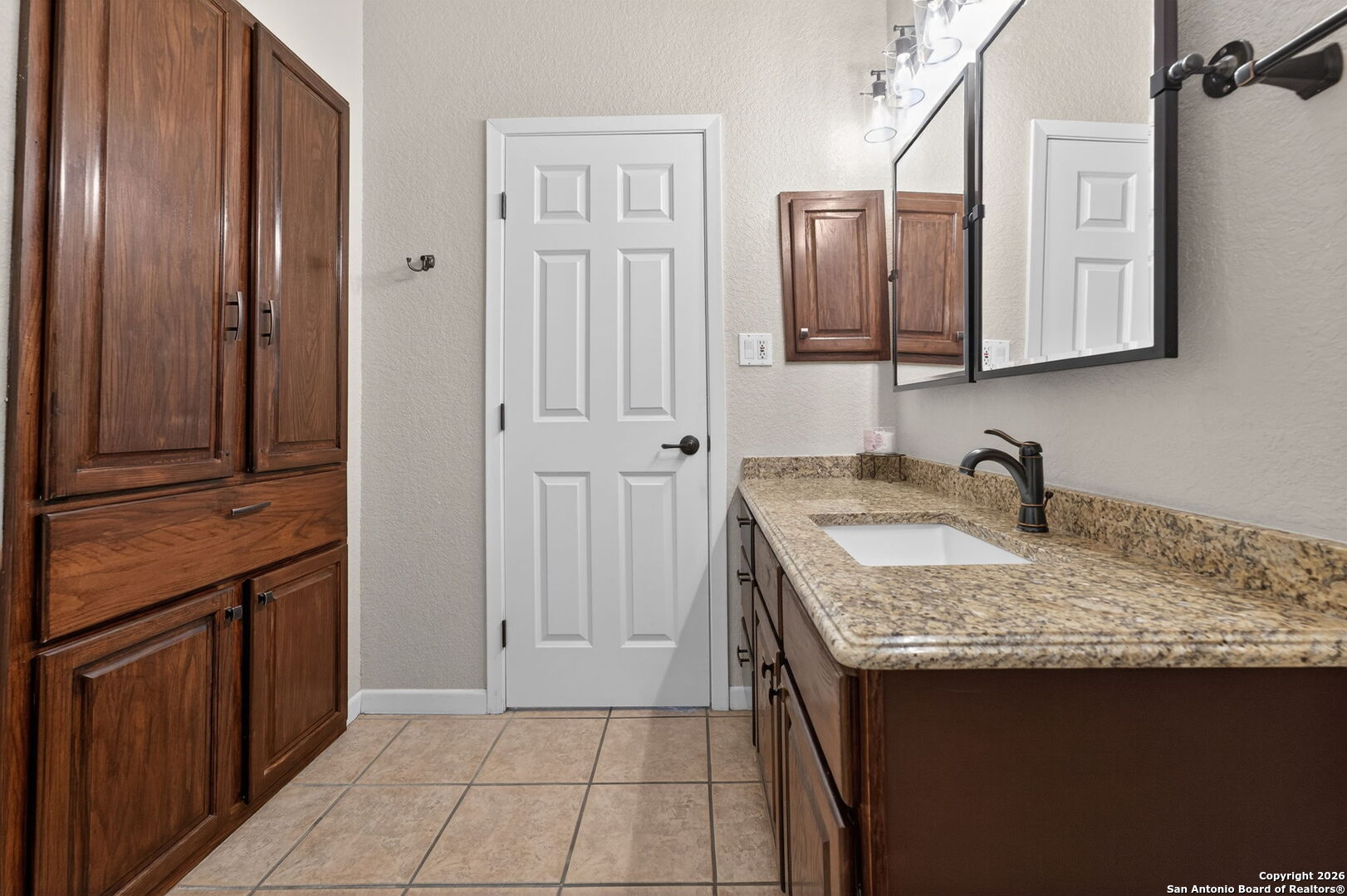 14802 Cross Xd Trail Helotes, TX 78023 - Photo 23 of 58 a bathroom with a granite countertop sink and a mirror