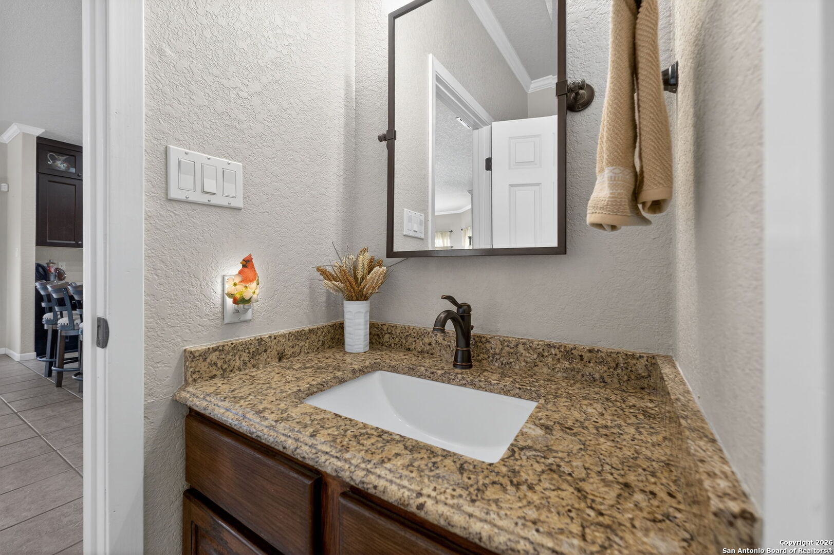 14802 Cross Xd Trail Helotes, TX 78023 - Photo 24 of 58 a bathroom with a granite countertop sink and a mirror