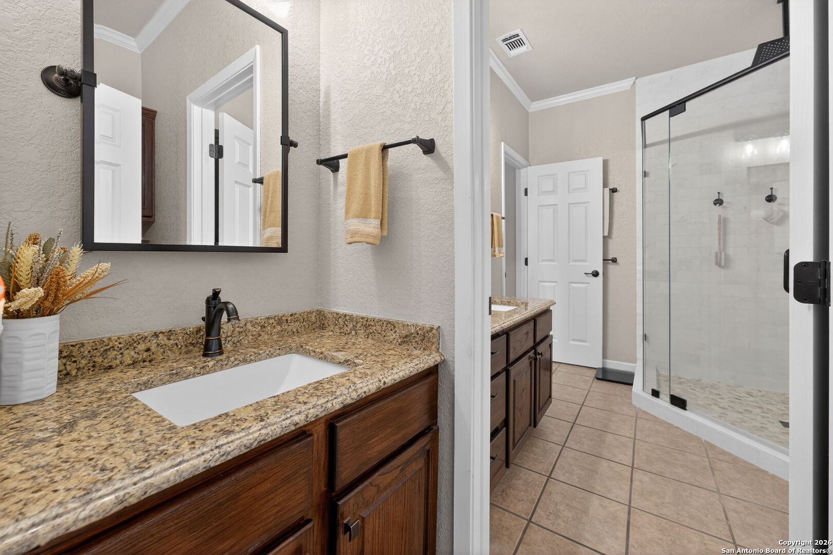14802 Cross Xd Trail Helotes, TX 78023 - Photo 25 of 58 a bathroom with a granite countertop sink a mirror and shower