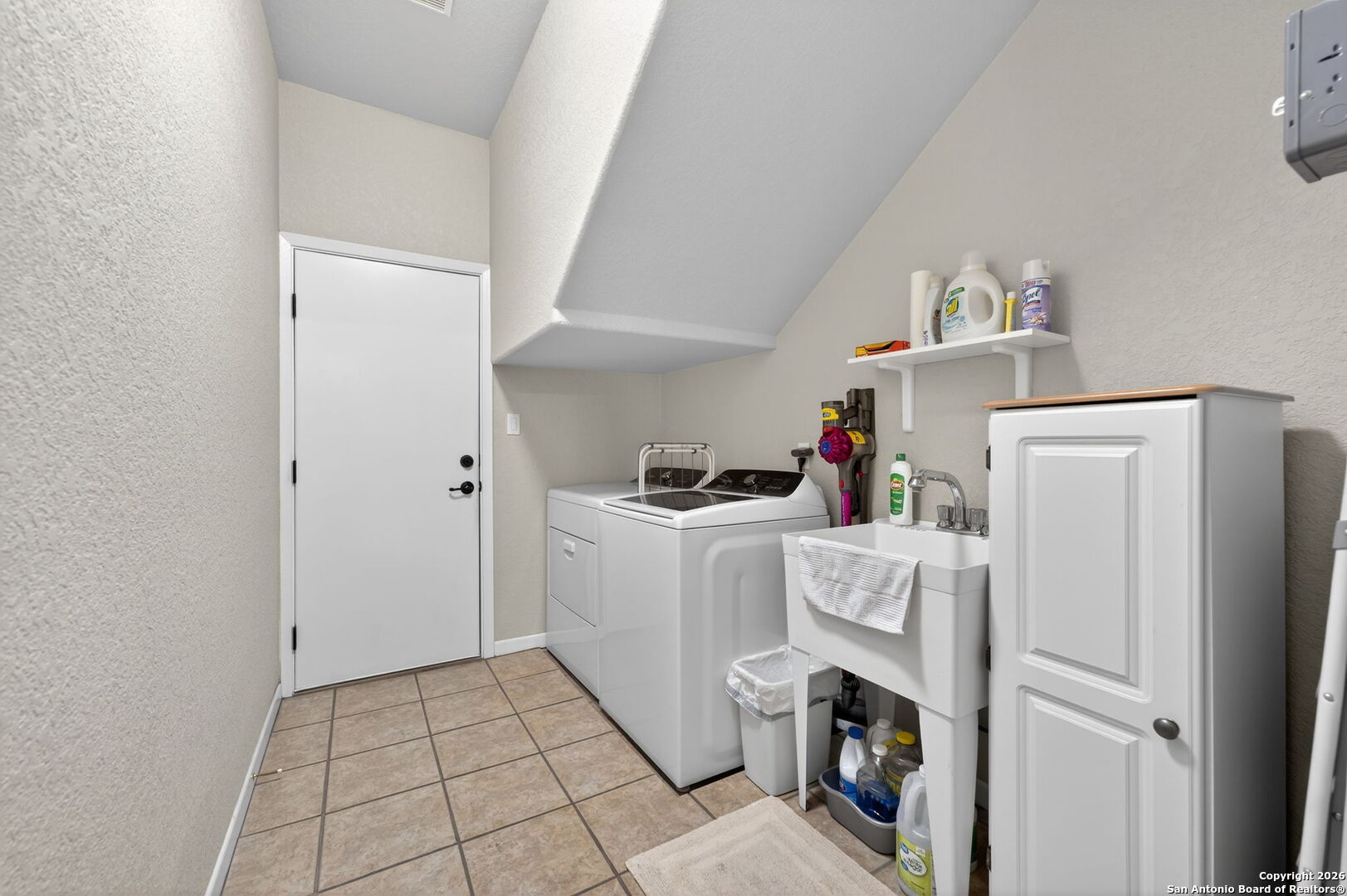 14802 Cross Xd Trail Helotes, TX 78023 - Photo 28 of 58 a utility room with cabinets washer and dryer