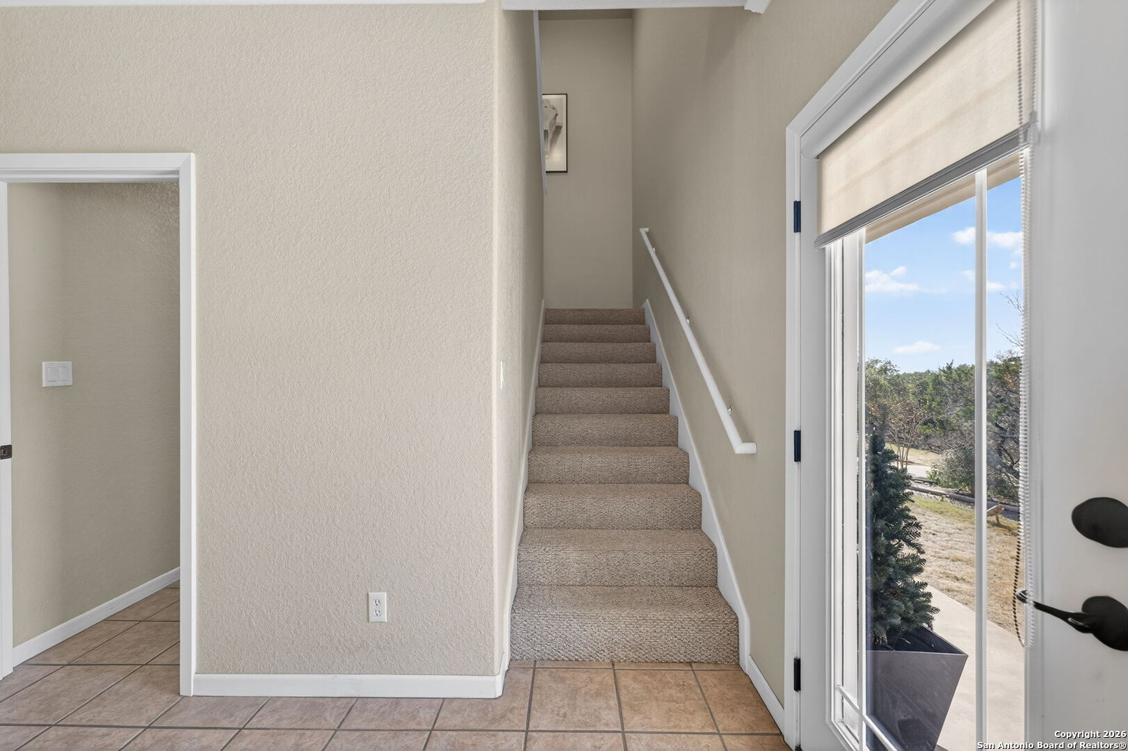 14802 Cross Xd Trail Helotes, TX 78023 - Photo 29 of 58 a view of staircase with white walls and windows