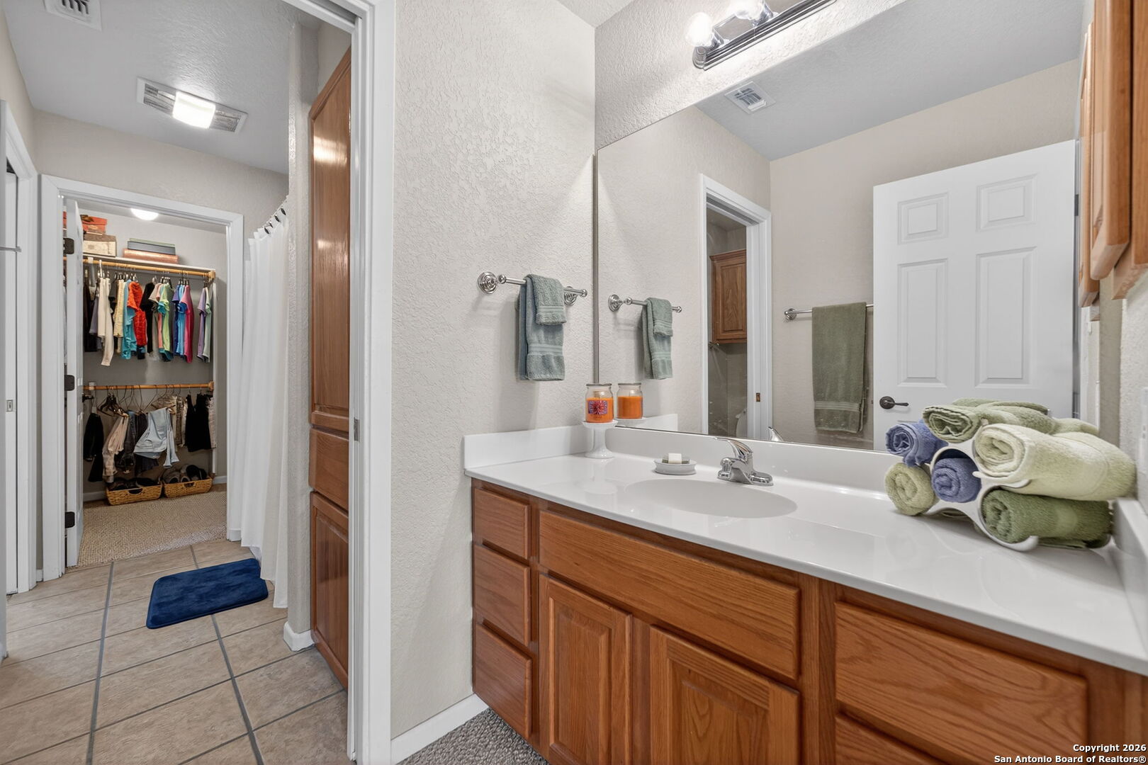 14802 Cross Xd Trail Helotes, TX 78023 - Photo 40 of 58 a en suite bathroom with a double vanity sink and a mirror