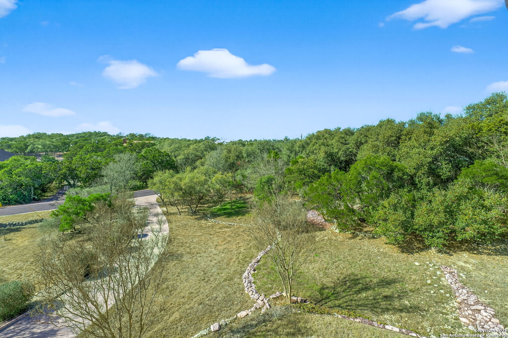 14802 Cross Xd Trail Helotes, TX 78023 - Photo 52 of 58 a view of a lake with a yard