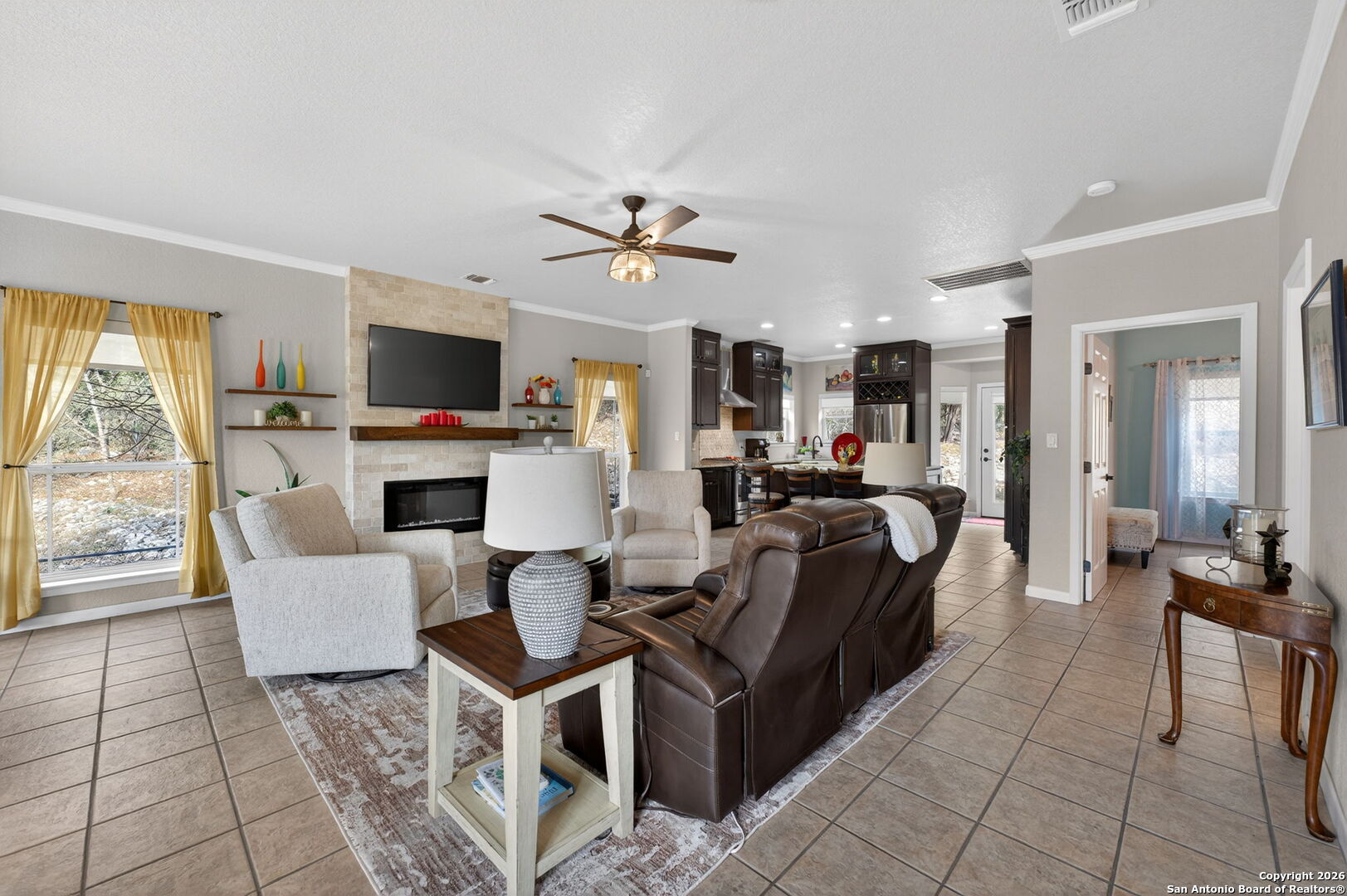 14802 Cross Xd Trail Helotes, TX 78023 - Photo 6 of 58 a living room with furniture a fireplace and a flat screen tv