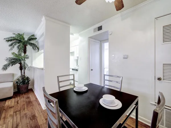 a view of a workspace with a table and chair in a room