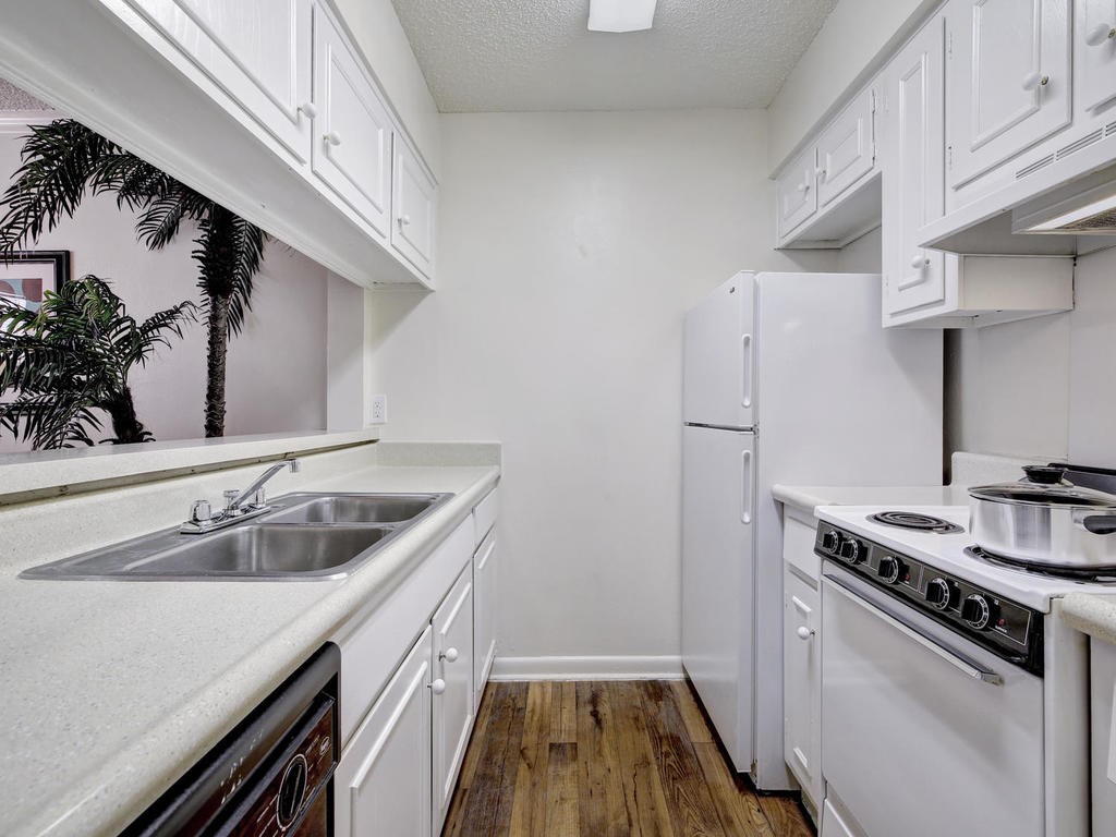 4553 Guadalupe Street, Unit 1BR Austin, TX 78751 - Photo 13 of 31 a kitchen with a sink stove and refrigerator