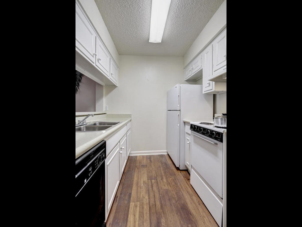 4553 Guadalupe Street, Unit 1BR Austin, TX 78751 - Photo 14 of 31 a kitchen with granite countertop a stove top oven and sink