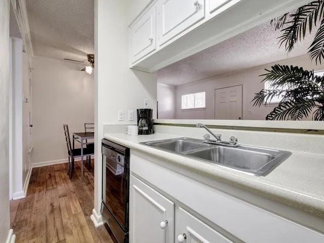 a kitchen with a sink and cabinets