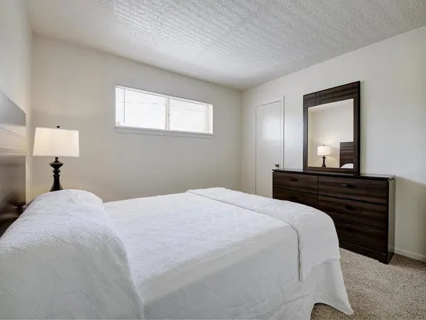 a bedroom with a bed and a mirror