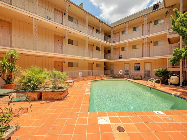 a view of a swimming pool with a lounge chairs