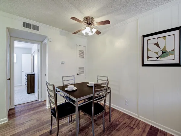 a view of a dining room with furniture and wooden floor