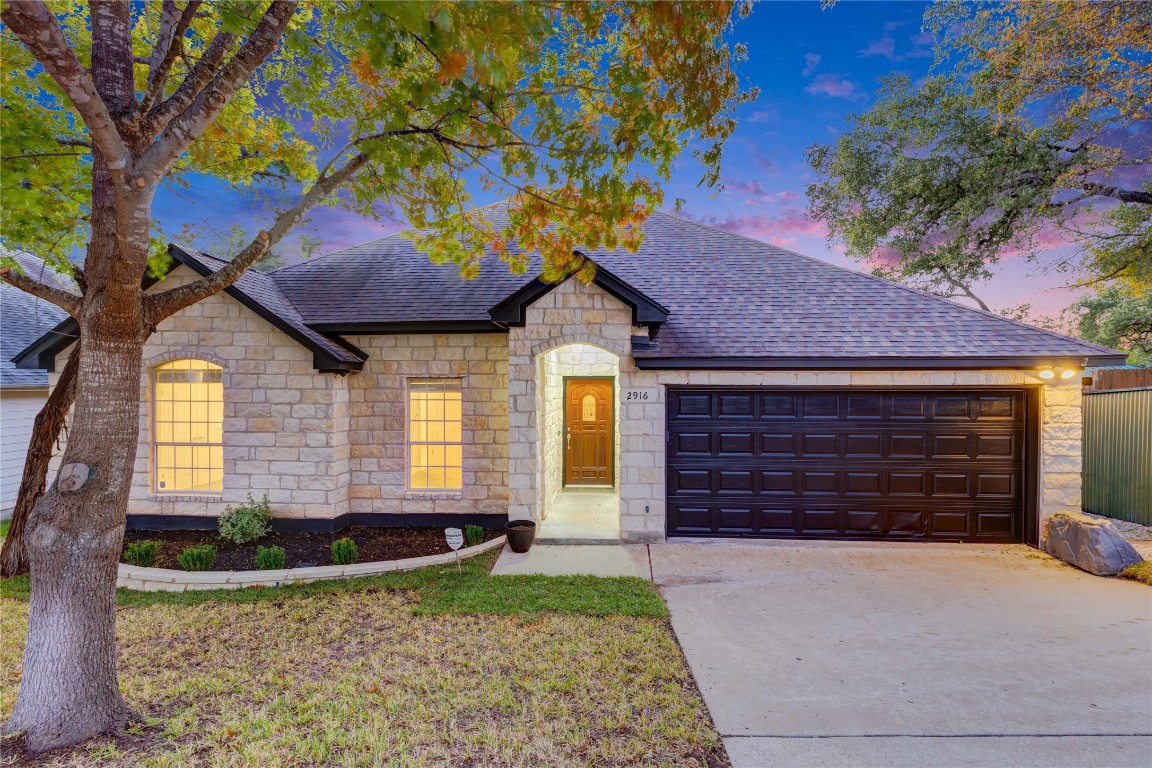 2916 Chisholm Trail Austin, TX 78734 - Photo 1 of 33 a front view of a house with a yard and garage