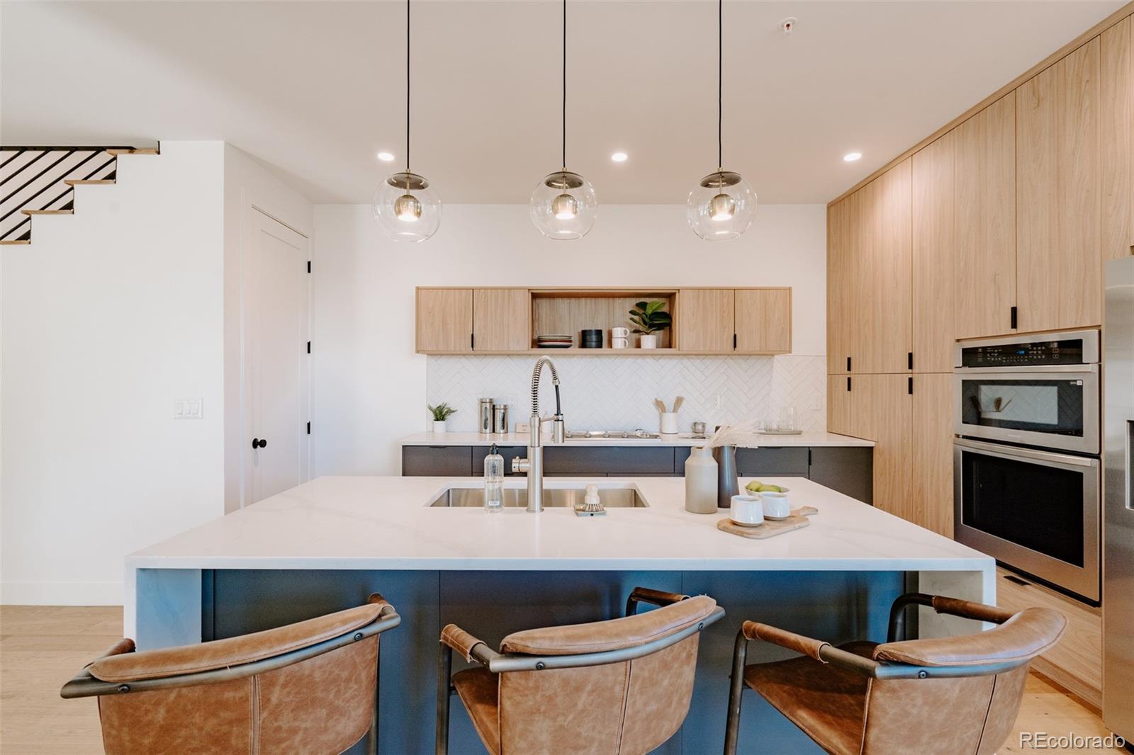 2530 Chase Edgewater, CO 80214 - Photo 12 of 37 a kitchen with stainless steel appliances a sink a stove a refrigerator and island