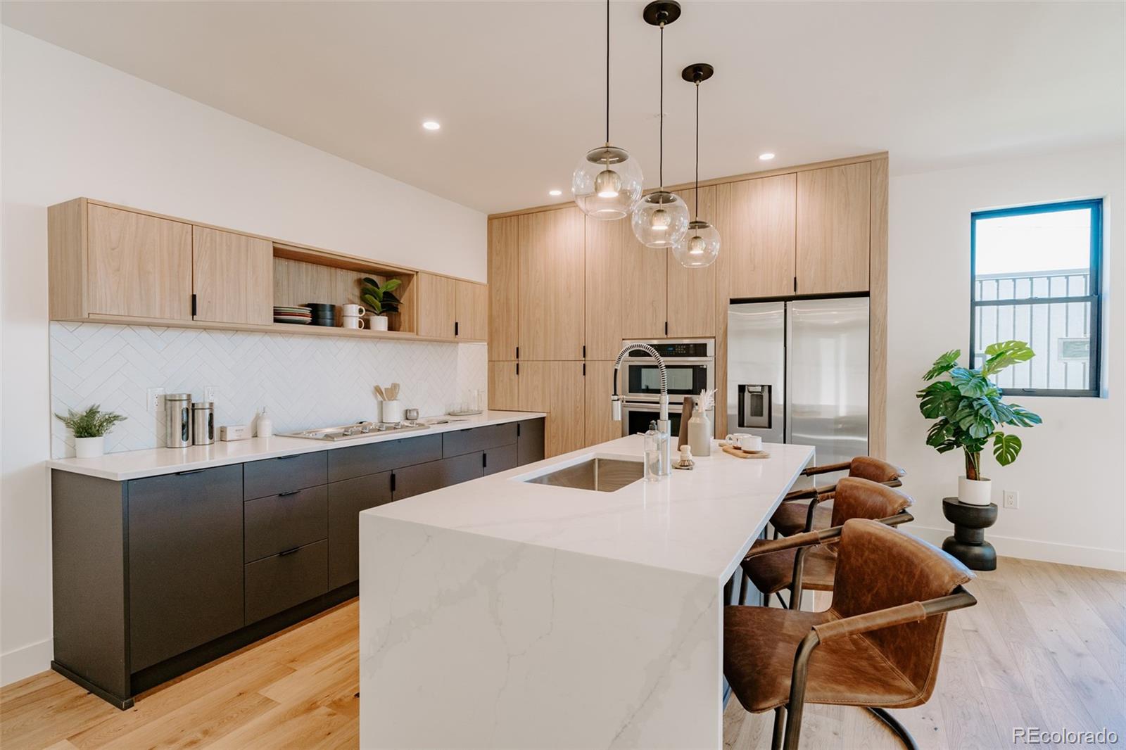 2530 Chase Edgewater, CO 80214 - Photo 13 of 37 a kitchen with sink a microwave and cabinets