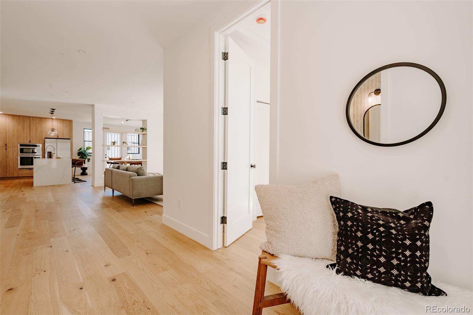 2530 Chase Edgewater, CO 80214 - Photo 21 of 37 a living room with furniture a wooden floor and a large mirror