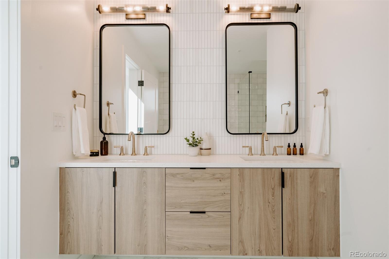 2530 Chase Edgewater, CO 80214 - Photo 23 of 37 a bathroom with double vanity sinks and a mirror