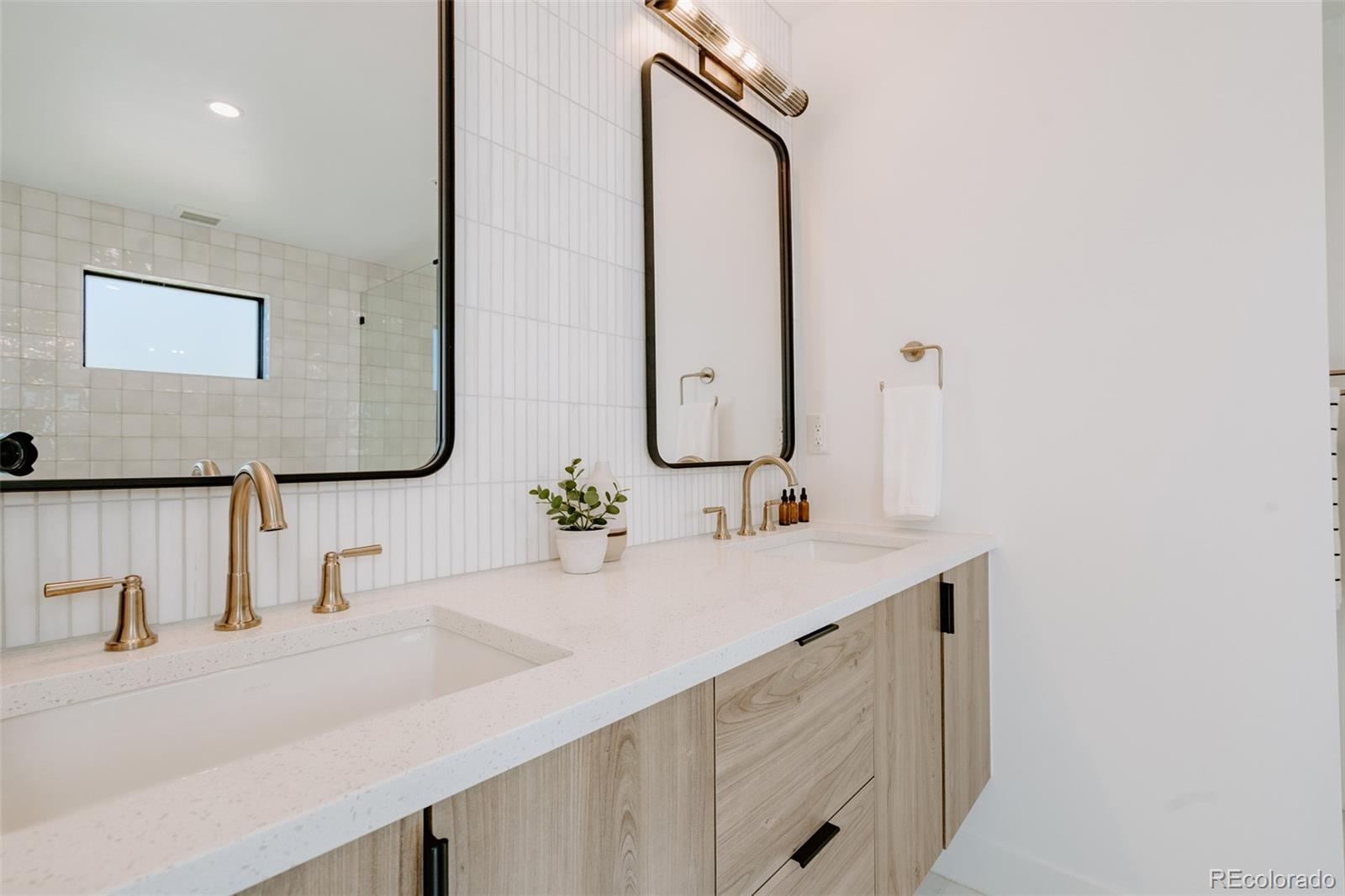 2530 Chase Edgewater, CO 80214 - Photo 24 of 37 a bathroom with a double vanity sink and a mirror