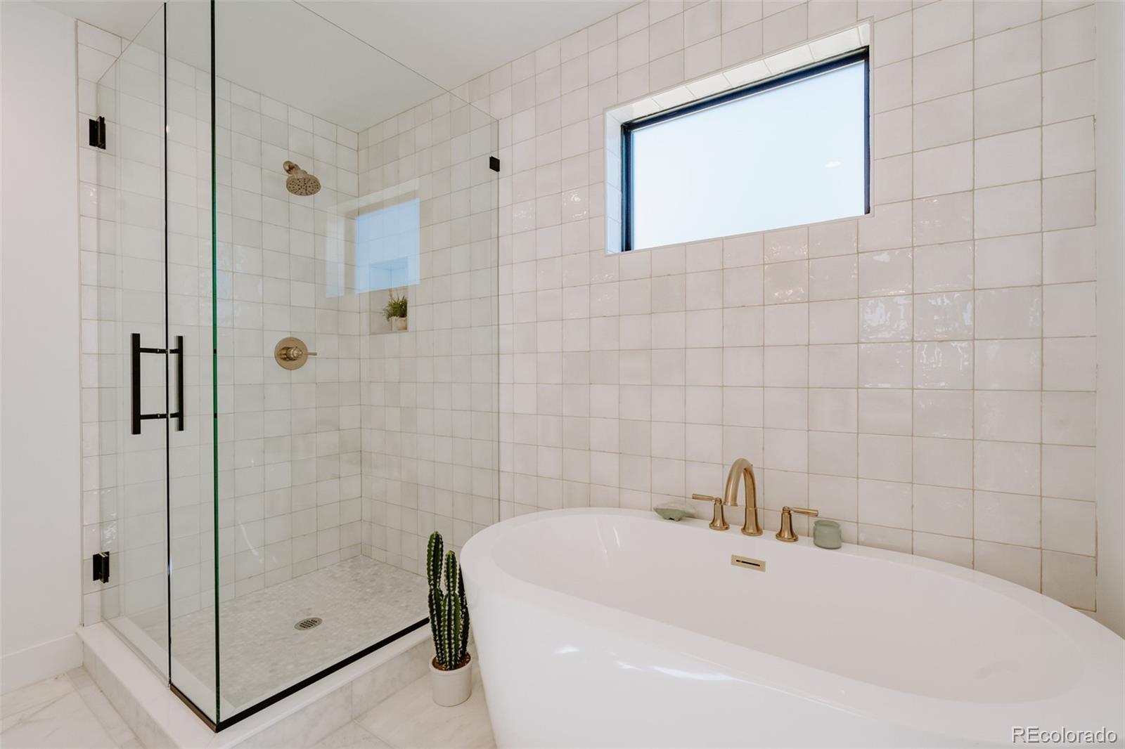 2530 Chase Edgewater, CO 80214 - Photo 25 of 37 a bathroom with a white tub
