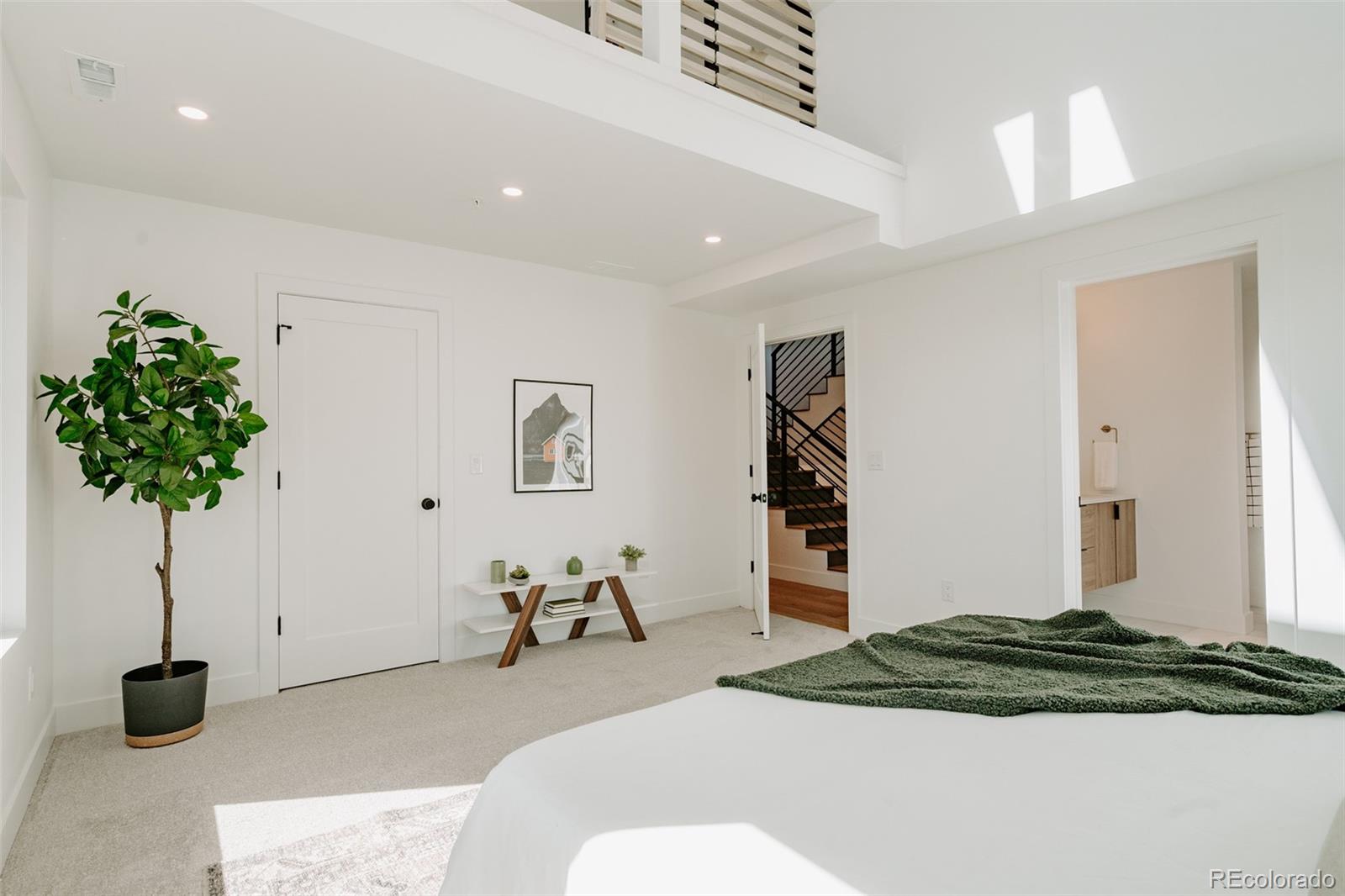 2530 Chase Edgewater, CO 80214 - Photo 26 of 37 a bedroom with a bed and a plant