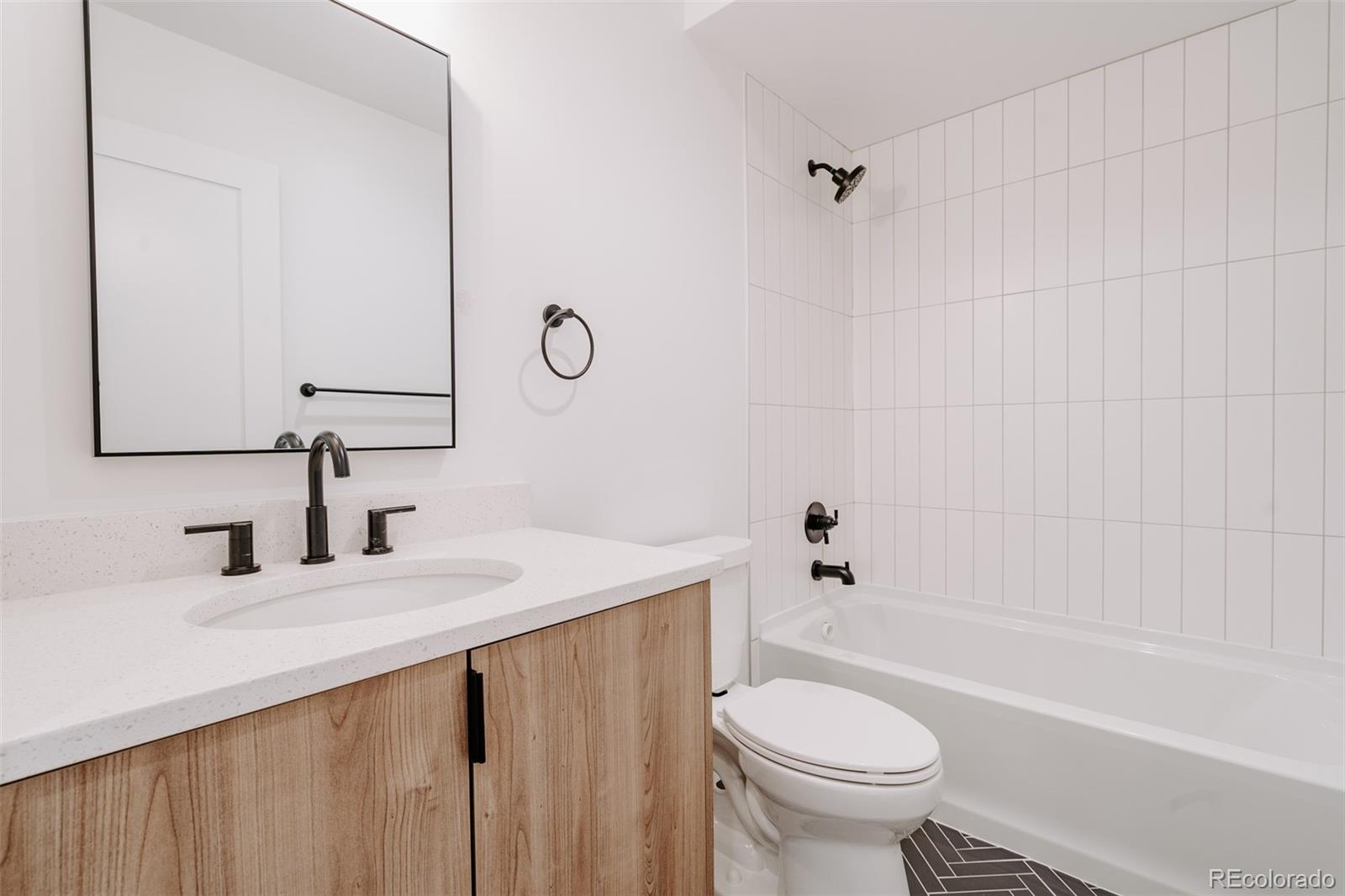 2530 Chase Edgewater, CO 80214 - Photo 28 of 37 a bathroom with a sink a toilet and a mirror