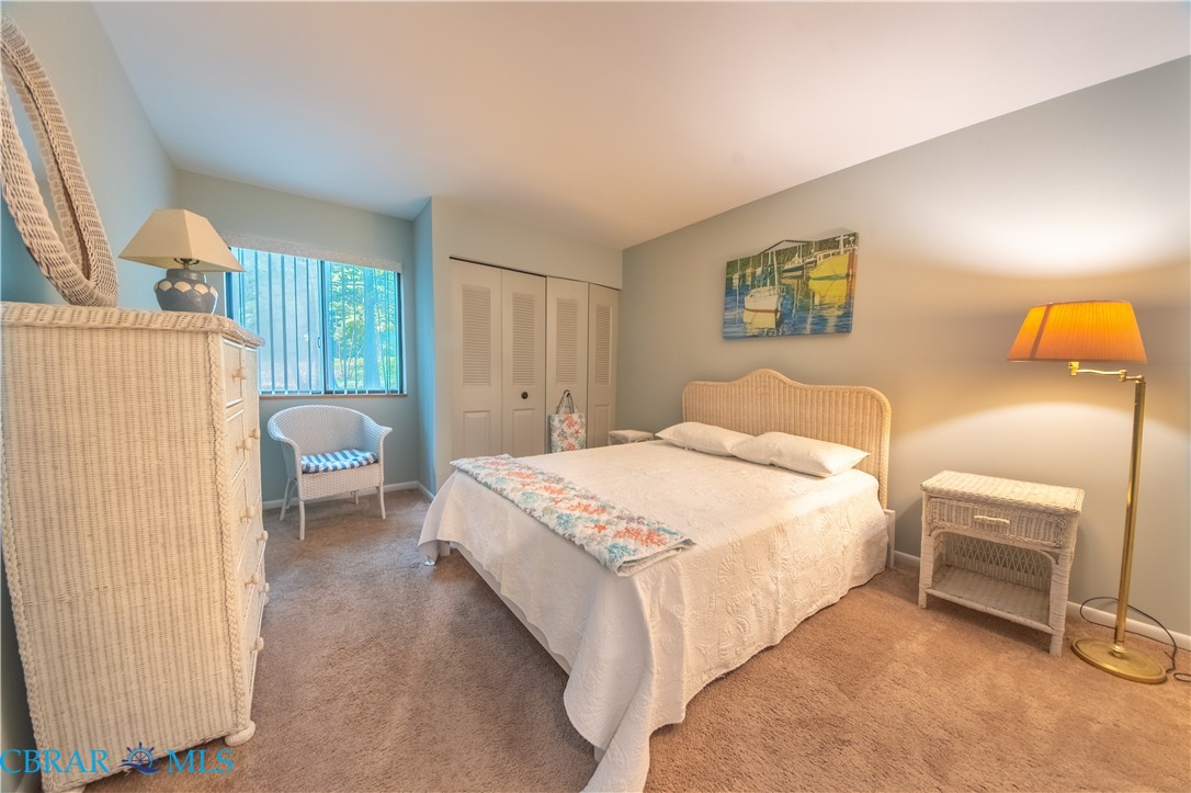 54 Villa Ridge Drive, Unit C Hartfield, VA 23071 - Photo 33 of 45 Carpeted bedroom featuring a closet and baseboards