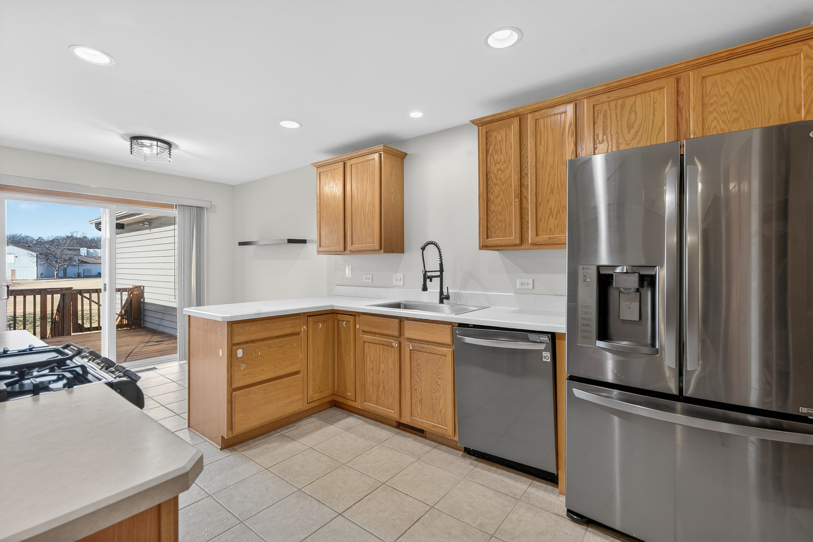 550 Madison Lane Elgin, IL 60123 - Photo 11 of 33 a kitchen with stainless steel appliances granite countertop a refrigerator sink and stove