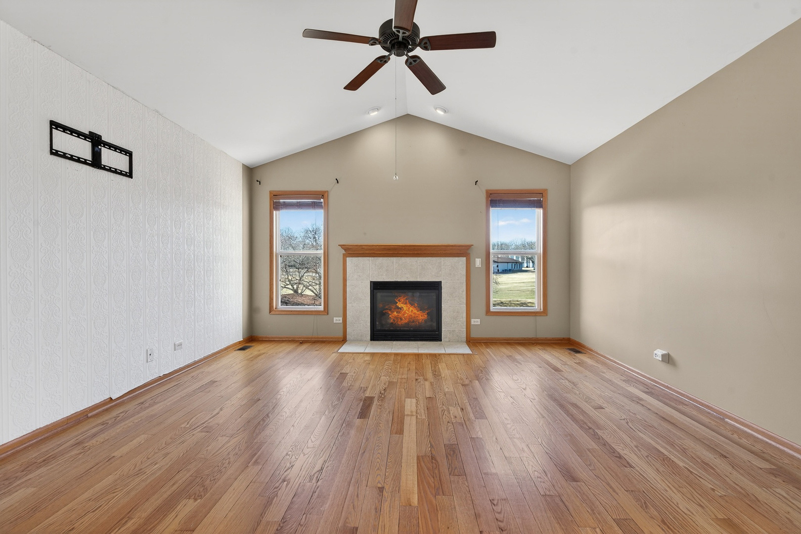 550 Madison Lane Elgin, IL 60123 - Photo 4 of 33 a view of an empty room with wooden floor fireplace and a window