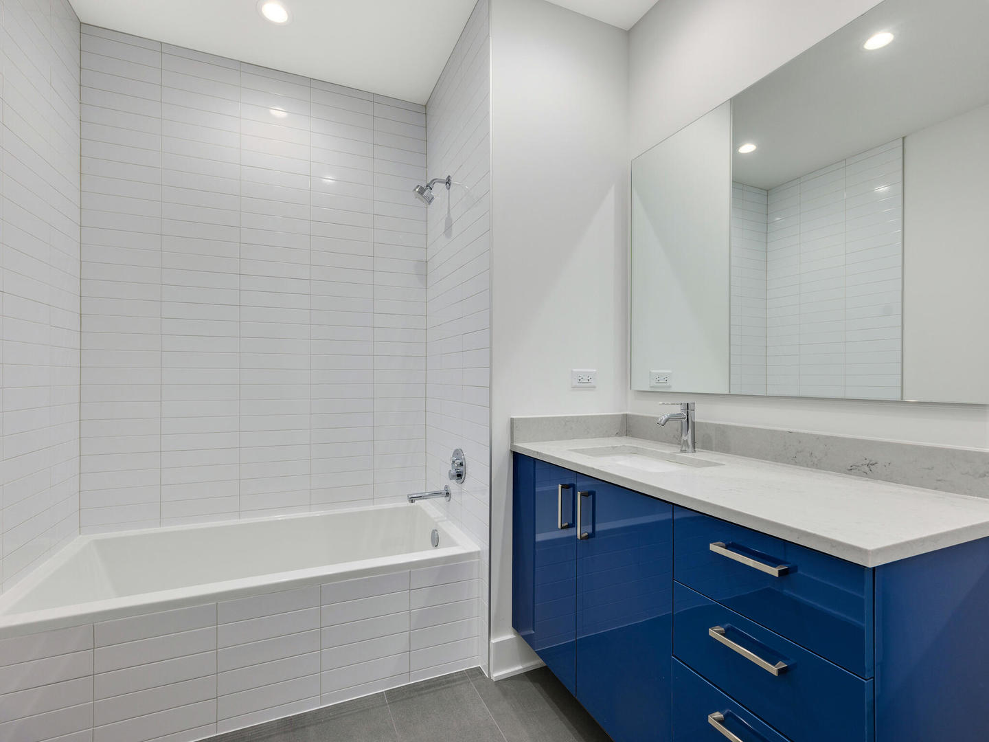 1701 West Webster Avenue, Unit 312 Chicago, IL 60614 - Photo 17 of 19 a bathroom with a sink double vanity granite tub shower and a mirror