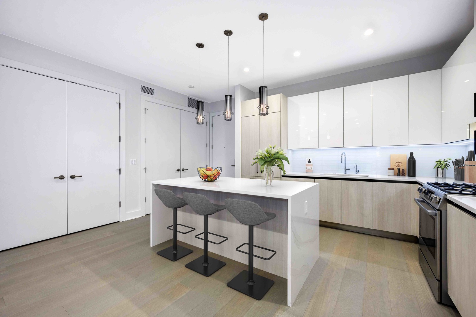 1701 West Webster Avenue, Unit 312 Chicago, IL 60614 - Photo 5 of 19 a kitchen with stainless steel appliances a sink a stove a refrigerator cabinets and chairs
