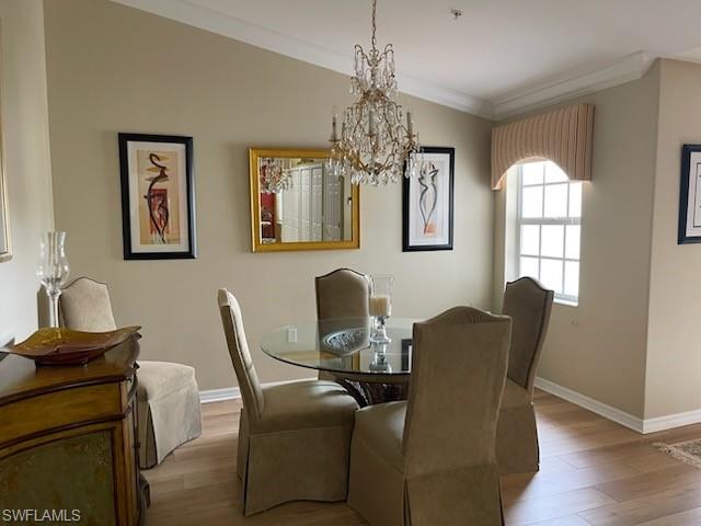 1380 Tiffany Lane, Unit 2204 Naples, FL 34105 - Photo 14 of 29 a view of a dining room with furniture and chandelier