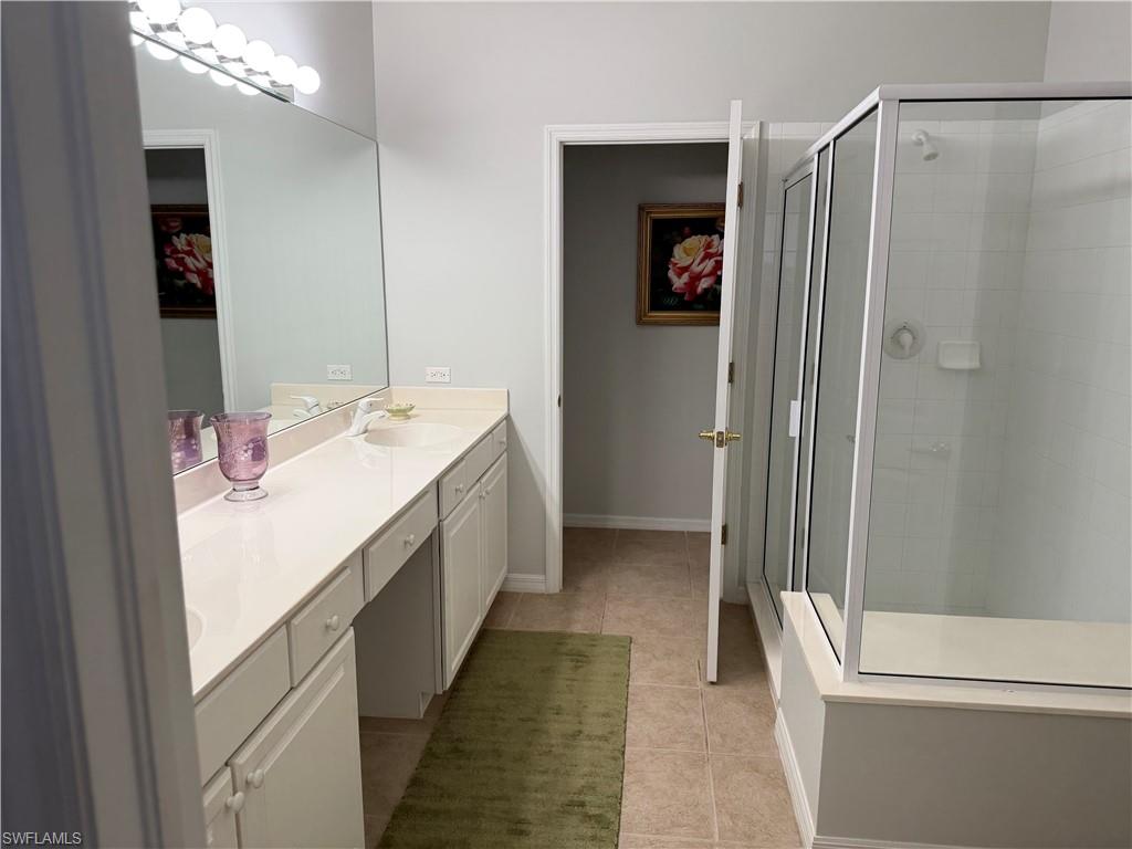 1380 Tiffany Lane, Unit 2204 Naples, FL 34105 - Photo 19 of 29 a bathroom with a double vanity sink and a mirror