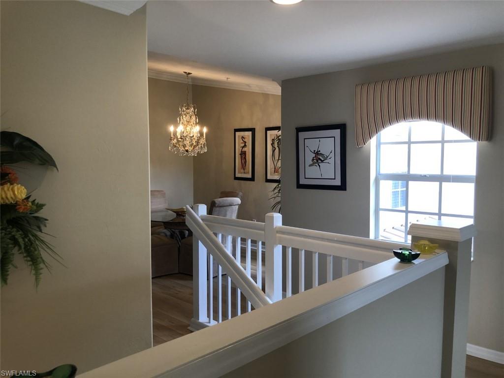 1380 Tiffany Lane, Unit 2204 Naples, FL 34105 - Photo 4 of 29 a view of staircase with furniture and a large window