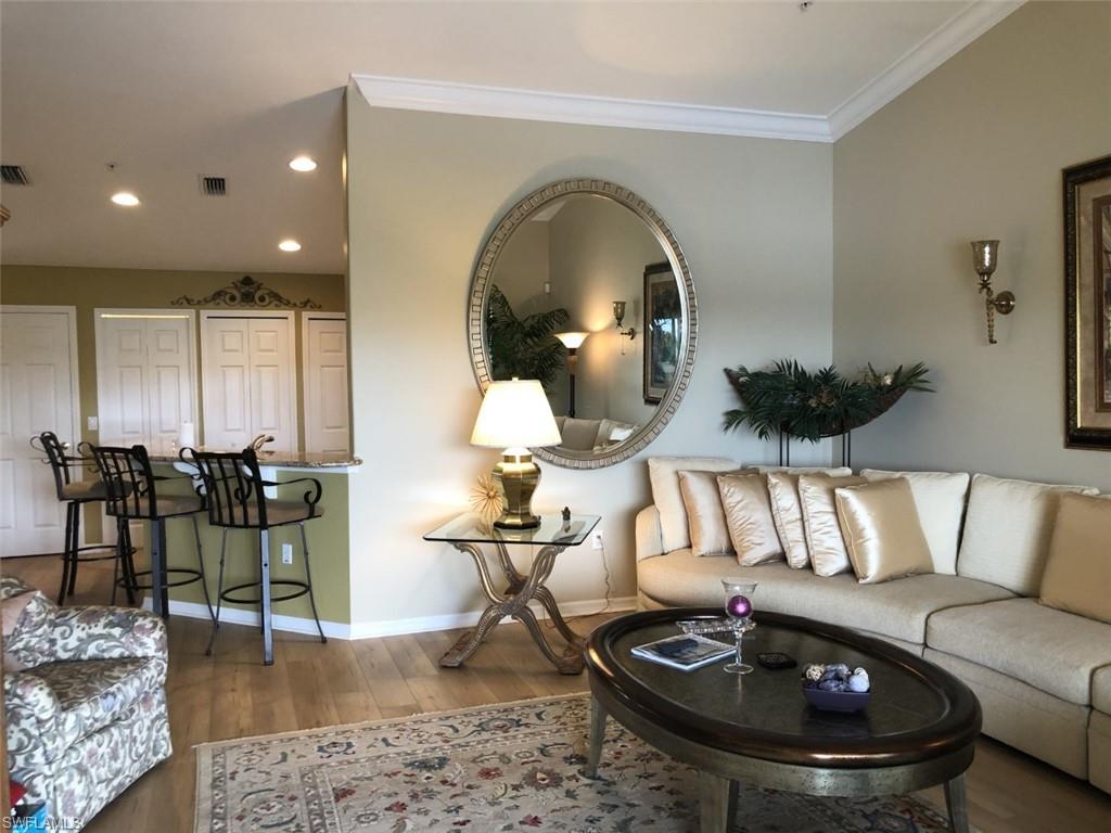 1380 Tiffany Lane, Unit 2204 Naples, FL 34105 - Photo 9 of 29 a living room with furniture and wooden floor