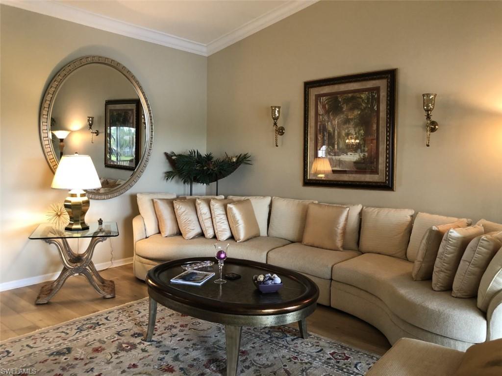 1380 Tiffany Lane, Unit 2204 Naples, FL 34105 - Photo 10 of 29 a living room with furniture a rug and a painting on the wall