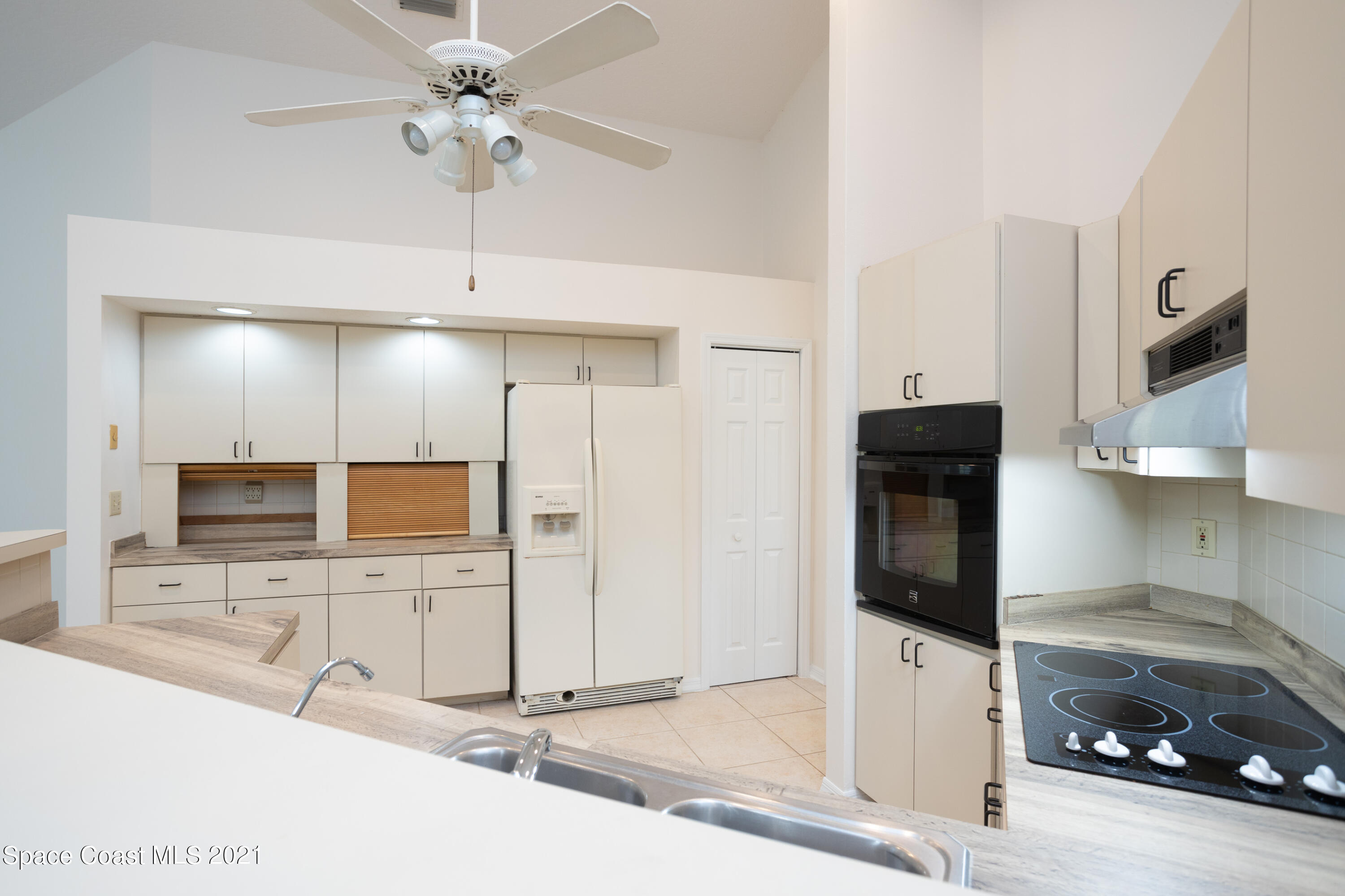 3930 Hammock Road Mims, FL 32754 - Photo 11 of 28 a view of a kitchen with a sink and a refrigerator