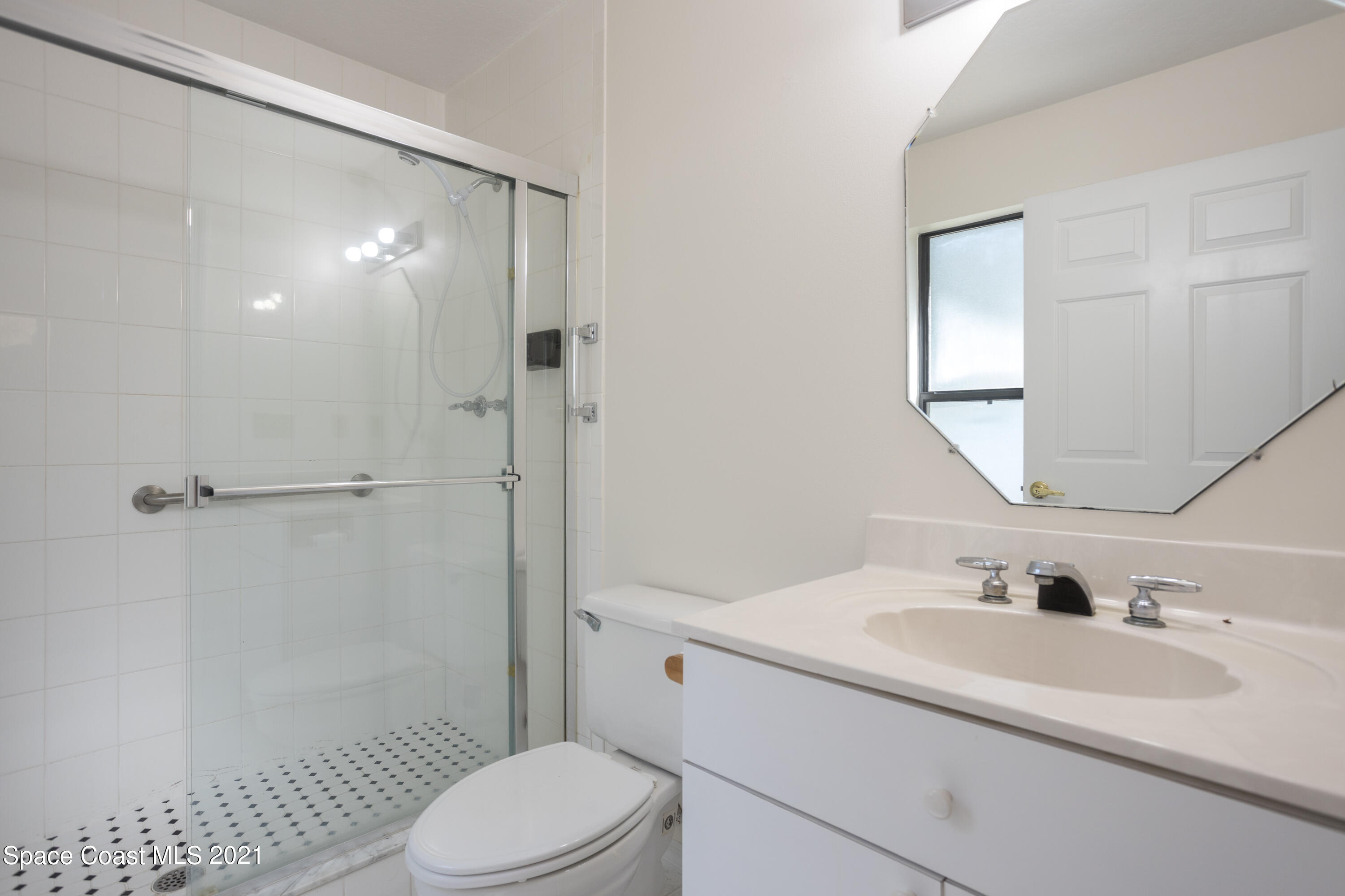 3930 Hammock Road Mims, FL 32754 - Photo 19 of 28 a bathroom with a sink a toilet and shower
