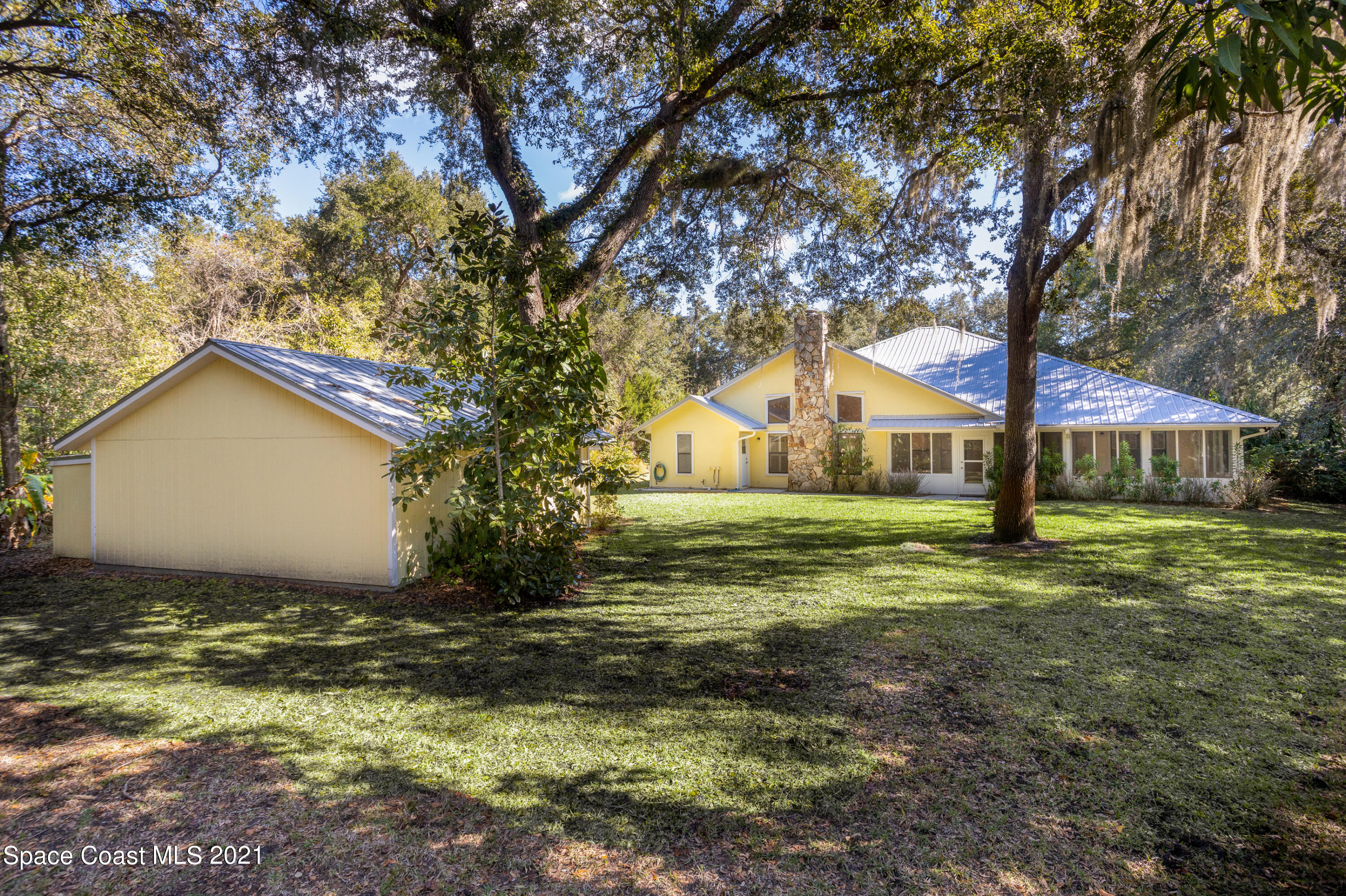 3930 Hammock Road Mims, FL 32754 - Photo 24 of 28 a view of a house with a yard
