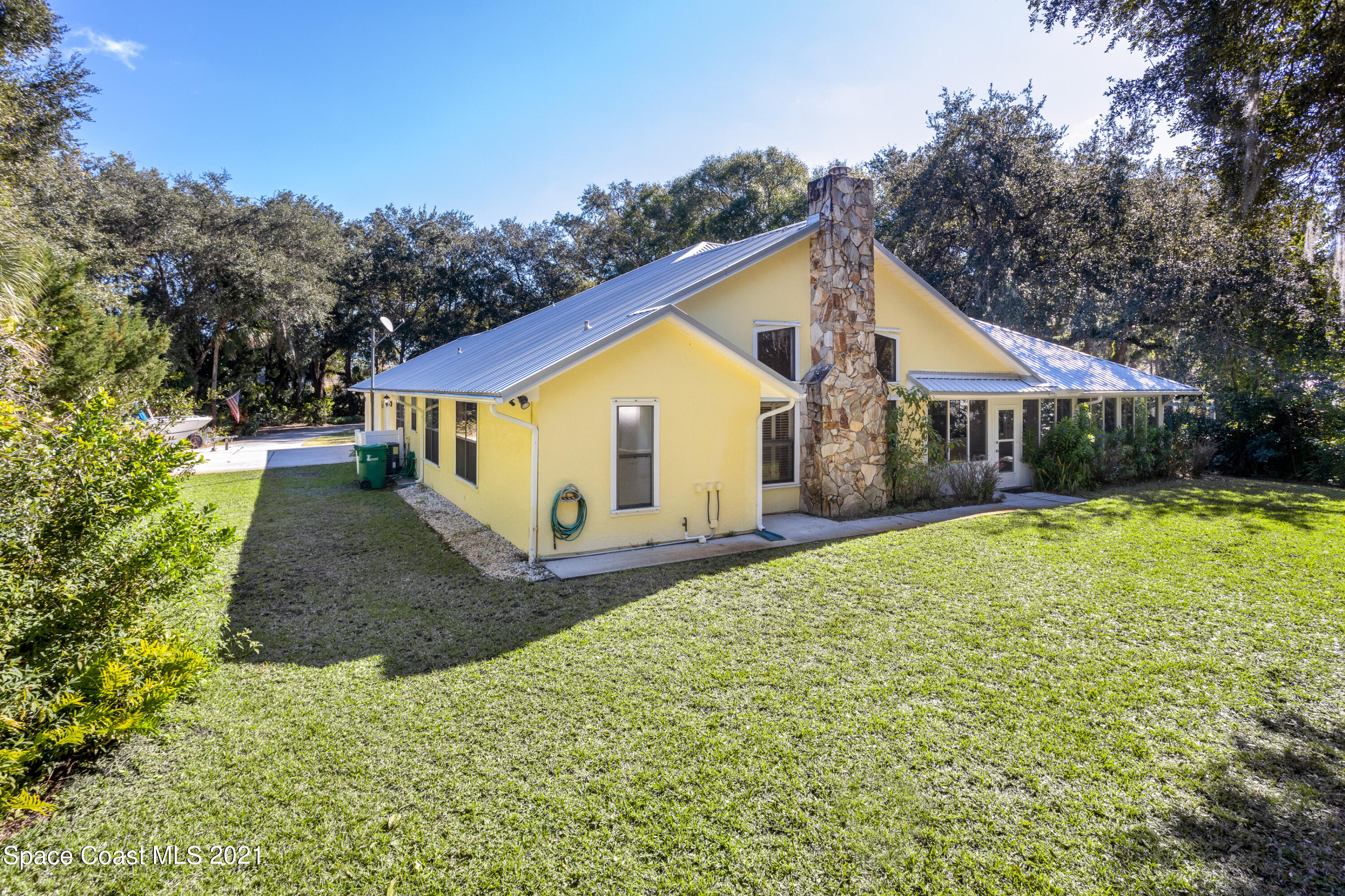 3930 Hammock Road Mims, FL 32754 - Photo 25 of 28 a view of a house with backyard and garden