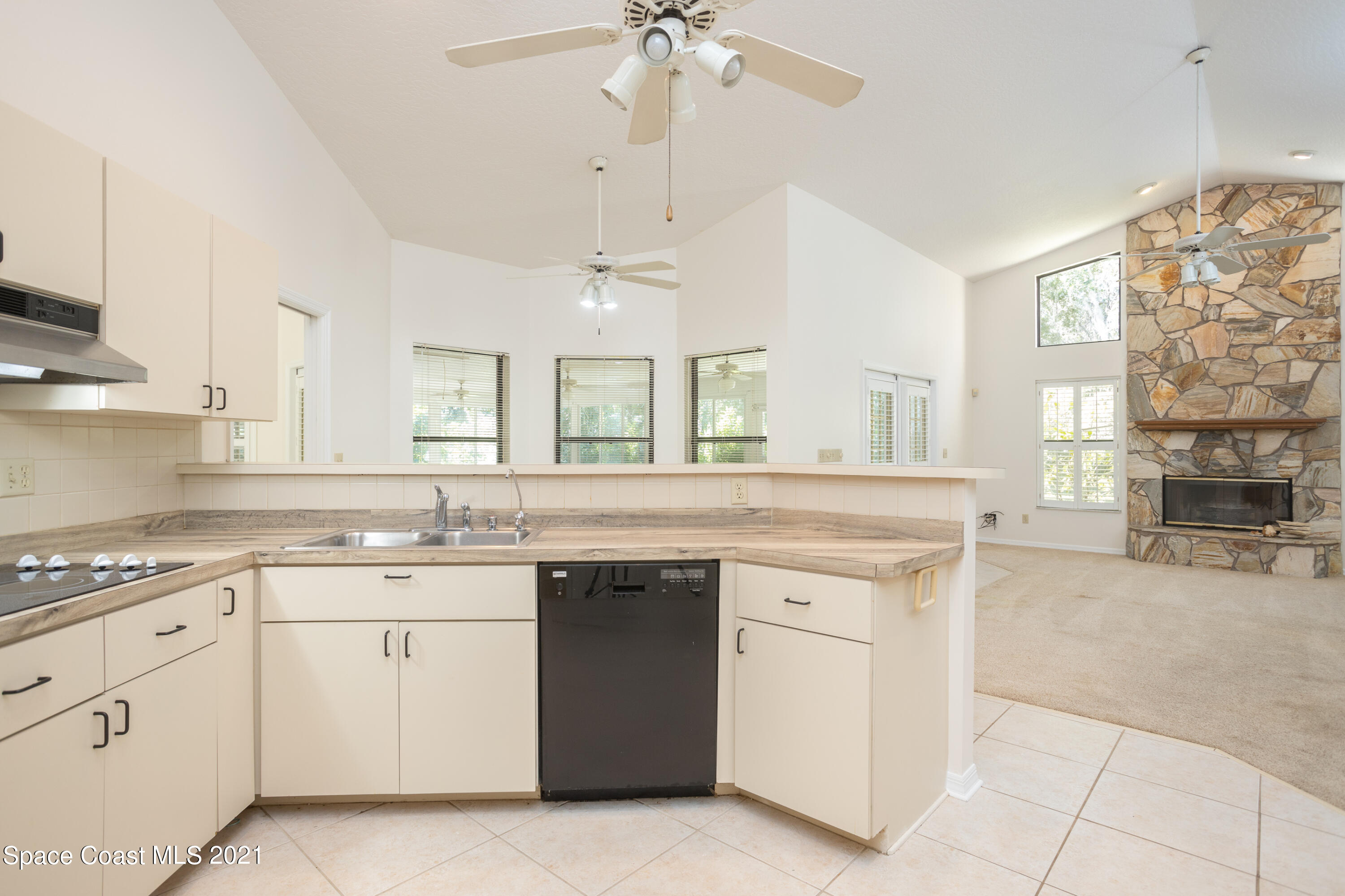 3930 Hammock Road Mims, FL 32754 - Photo 10 of 28 a kitchen with a sink stove and cabinets