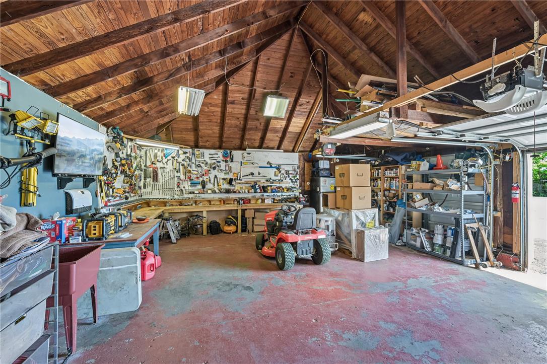 4065 Airport Road Allentown, PA 18109 - Photo 21 of 28 Functional garage workshop featuring exposed wood beams and comprehensive tool storage solutions.