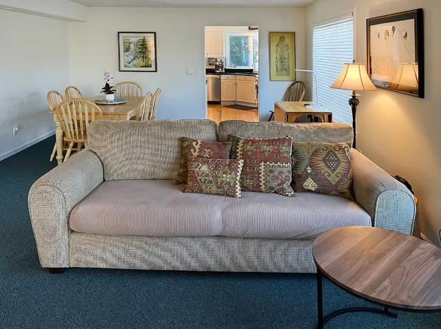 a living room with furniture and painting on the wall