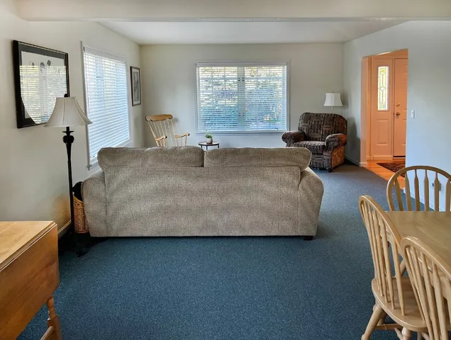 a bed room with a bed and a chair